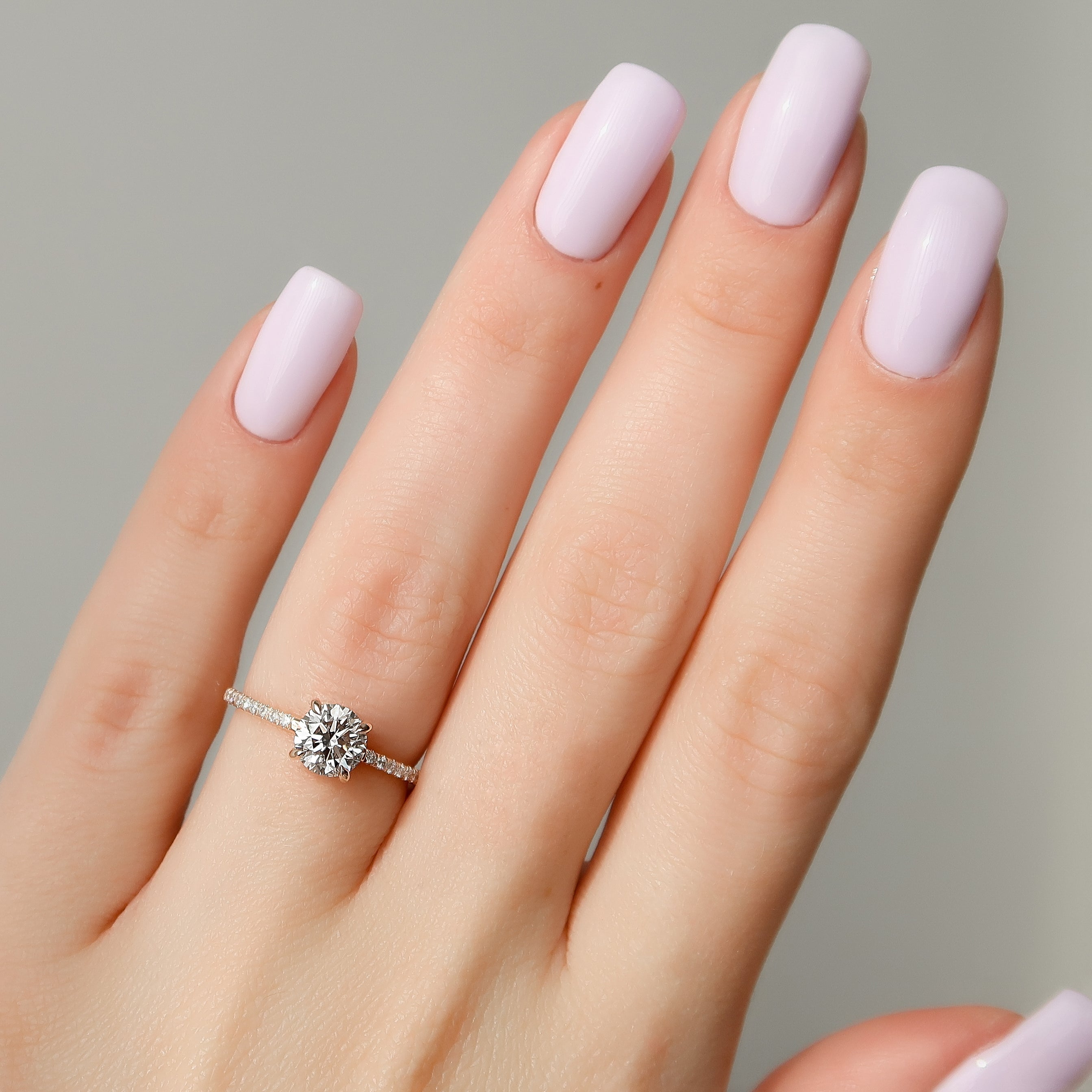 Round cut CVD diamond engagement ring with hidden halo and pave diamond band in white gold