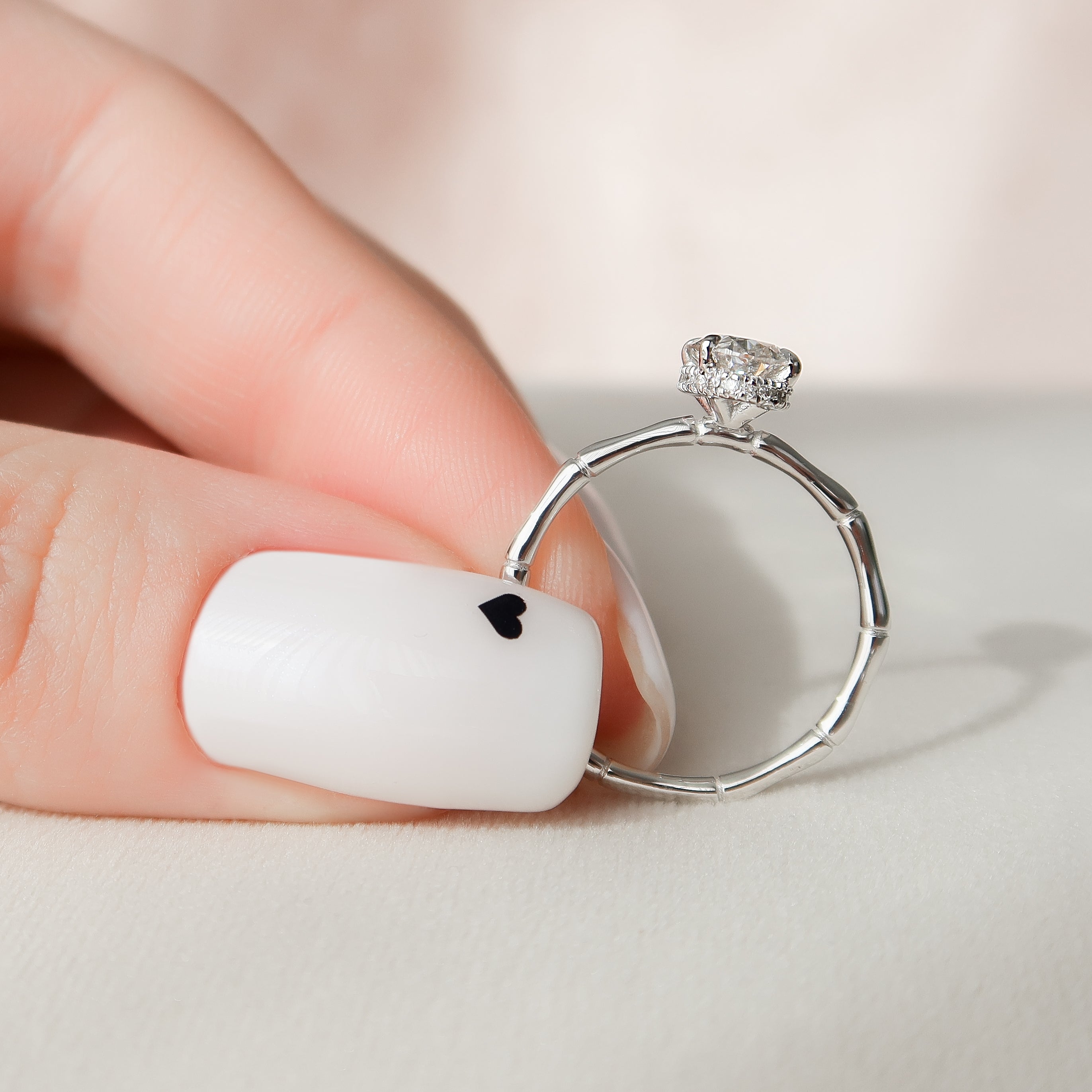 Oval cut CVD diamond engagement ring with hidden halo detail in platinum setting