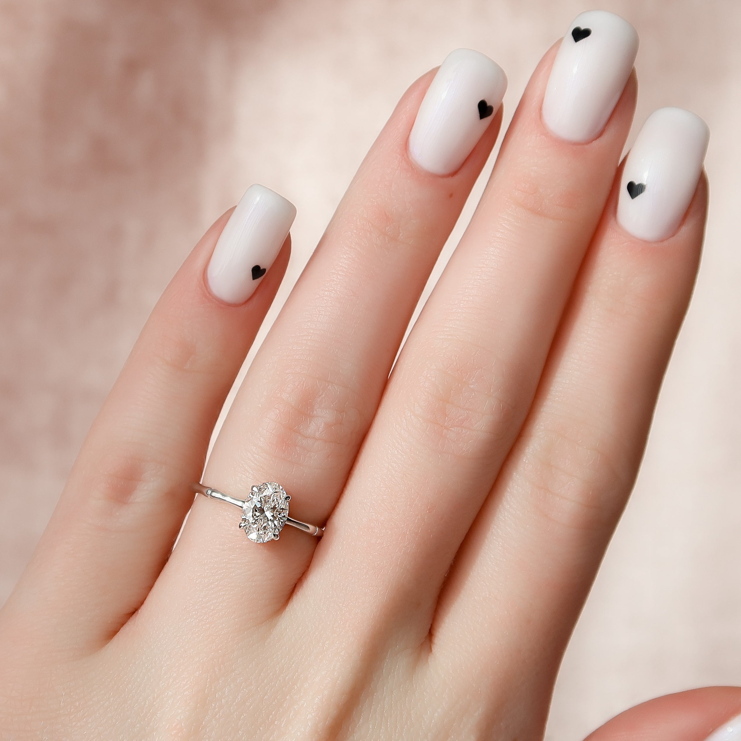 Oval cut CVD diamond engagement ring with hidden halo detail in platinum setting