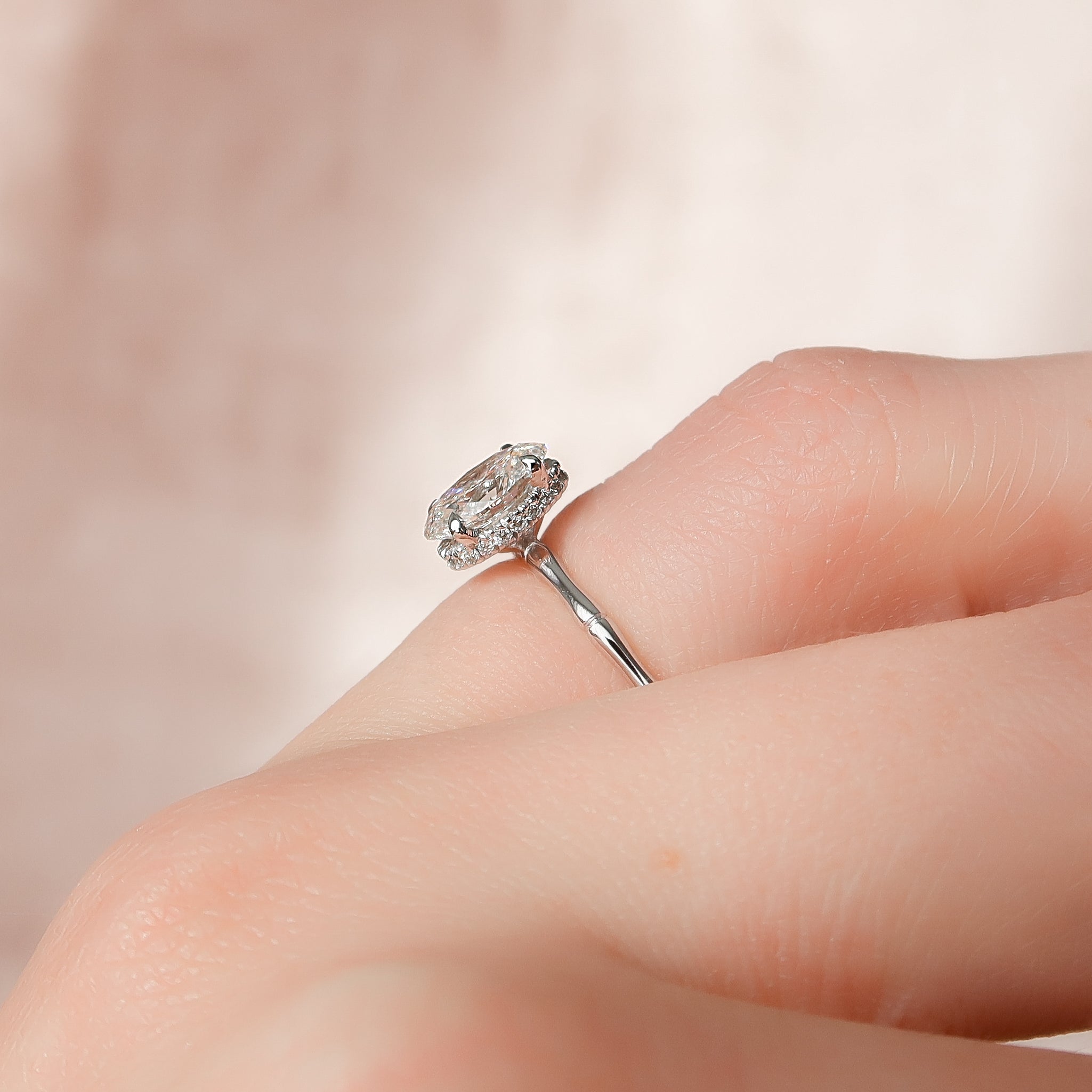 Oval cut CVD diamond engagement ring with hidden halo detail in platinum setting