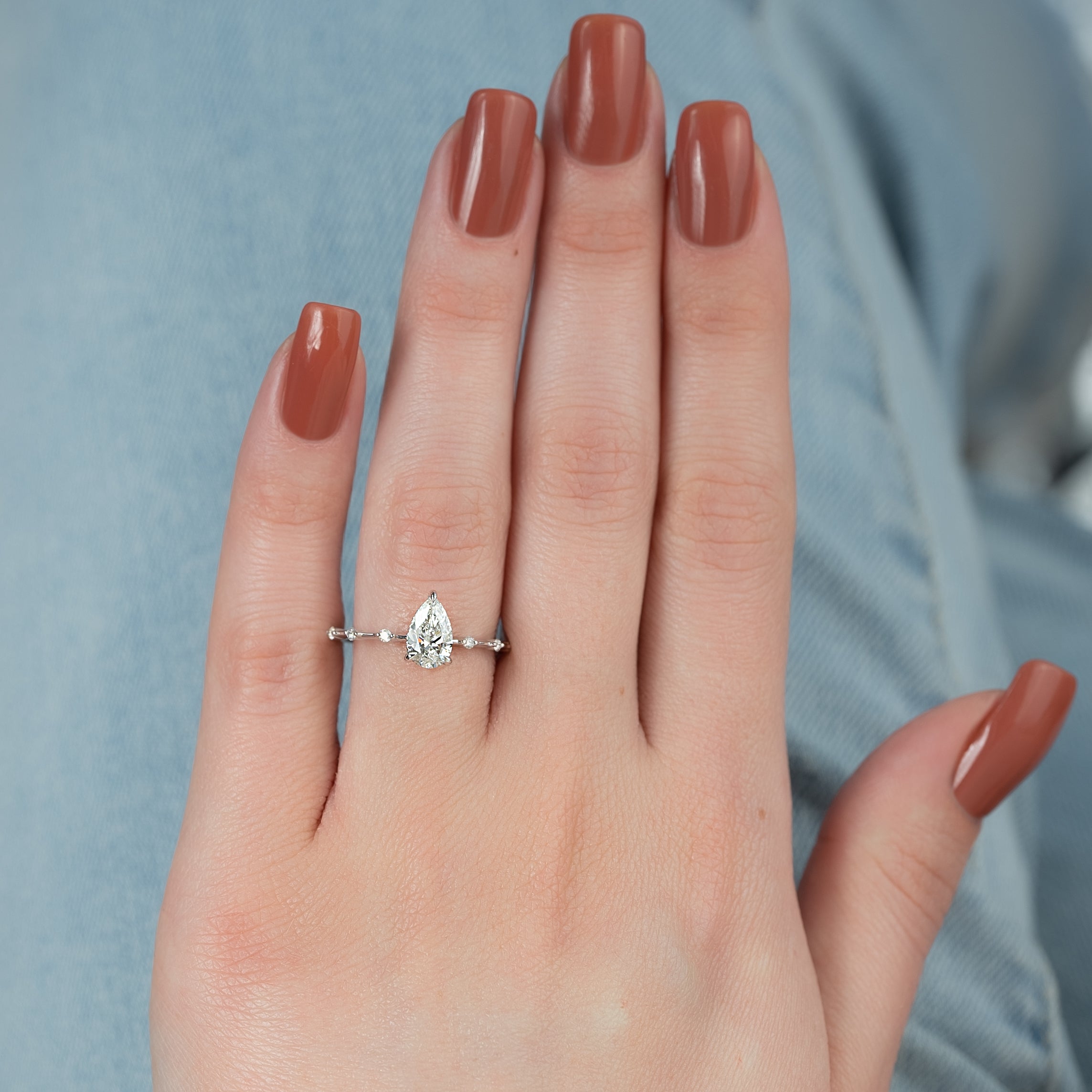Pear cut CVD diamond engagement ring with hidden halo and dainty pave band in white gold