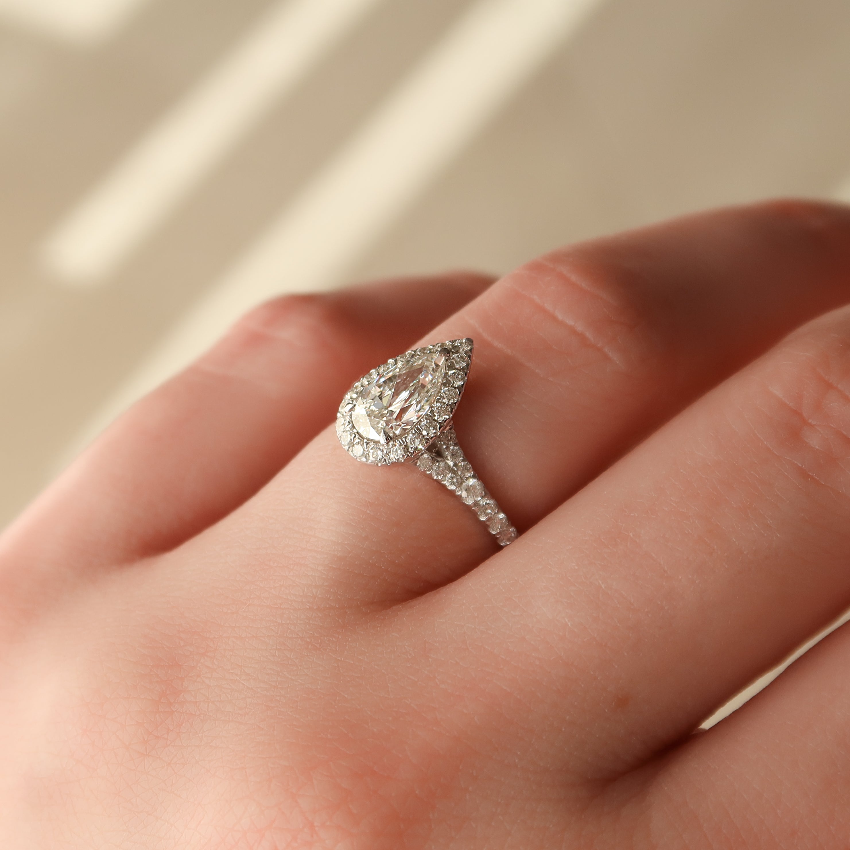 Pear cut CVD diamond halo engagement ring with pave diamond band in white gold