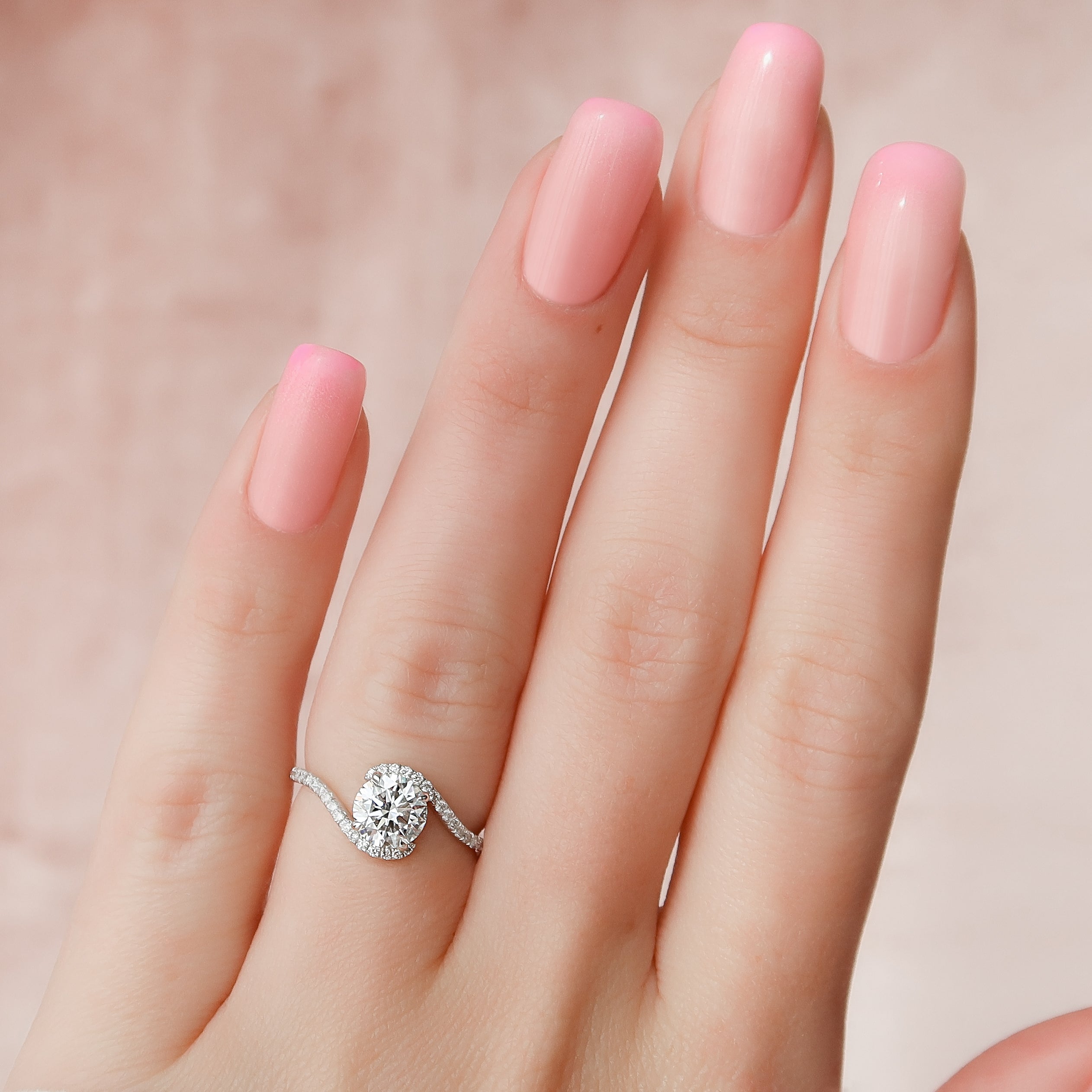 Round cut moissanite engagement ring in bypass setting with white gold band