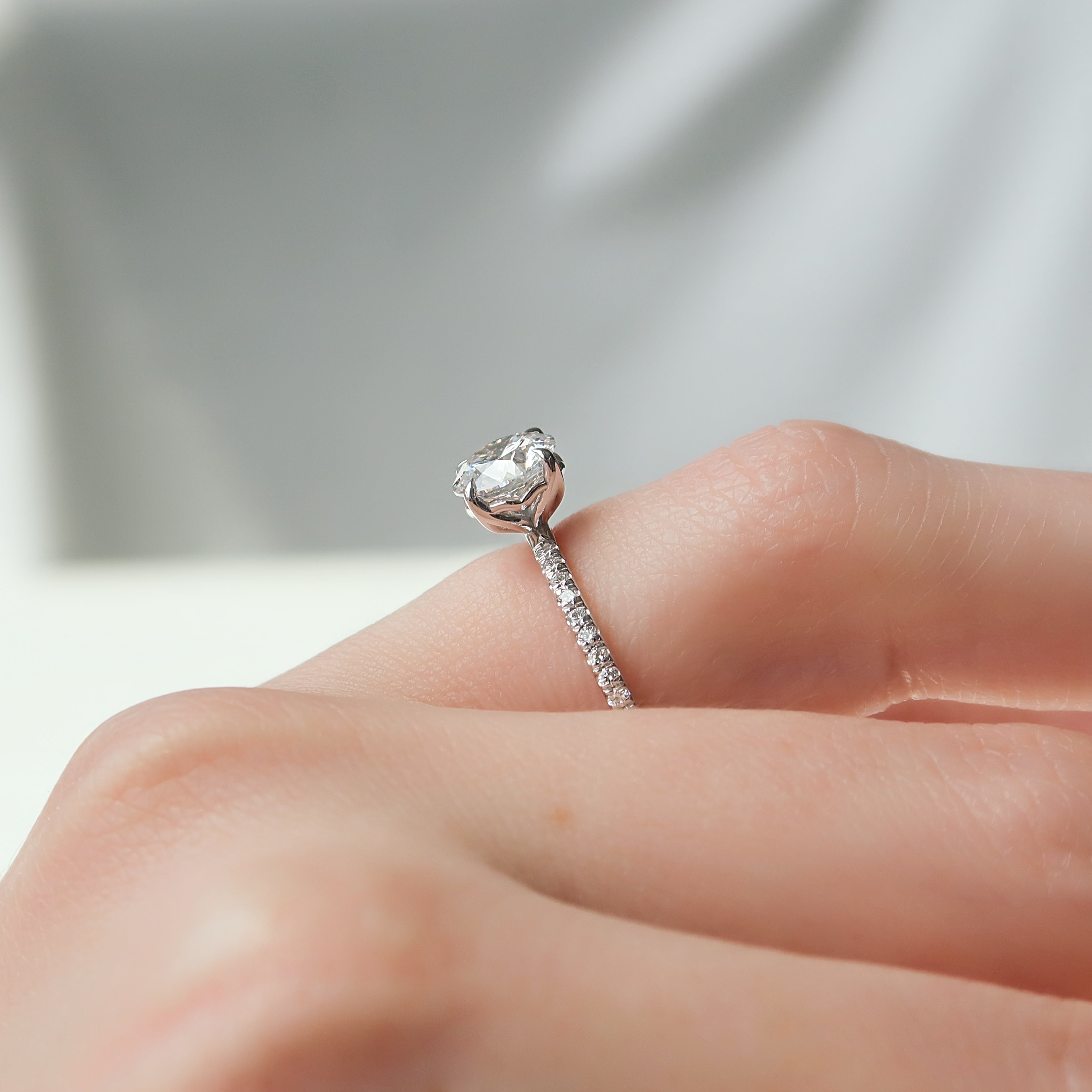 Round cut CVD diamond engagement ring with delicate pave diamond band in platinum