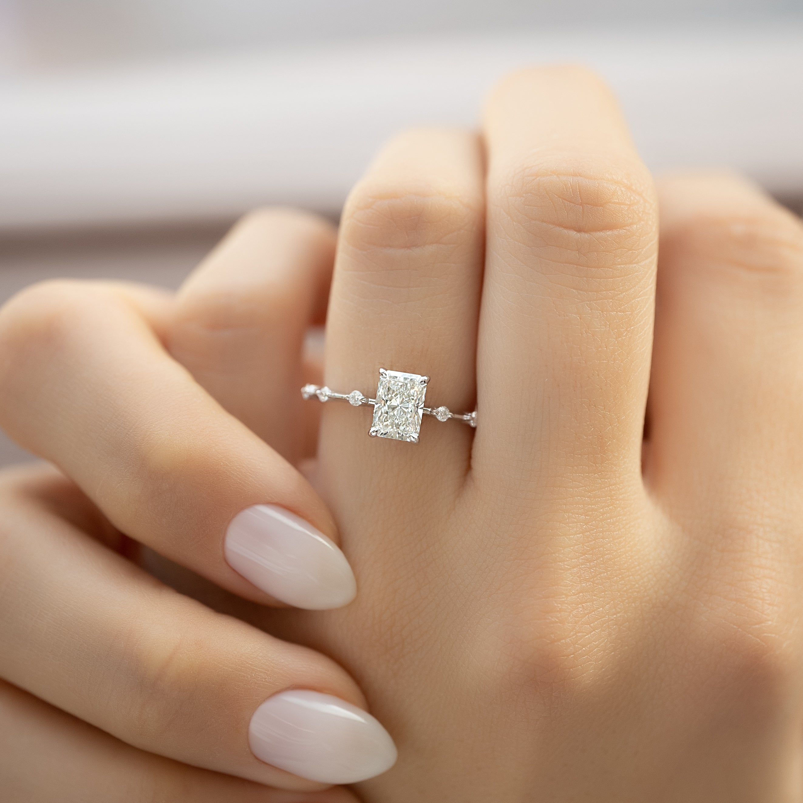 Radiant cut CVD diamond engagement ring with hidden halo in dainty platinum setting
