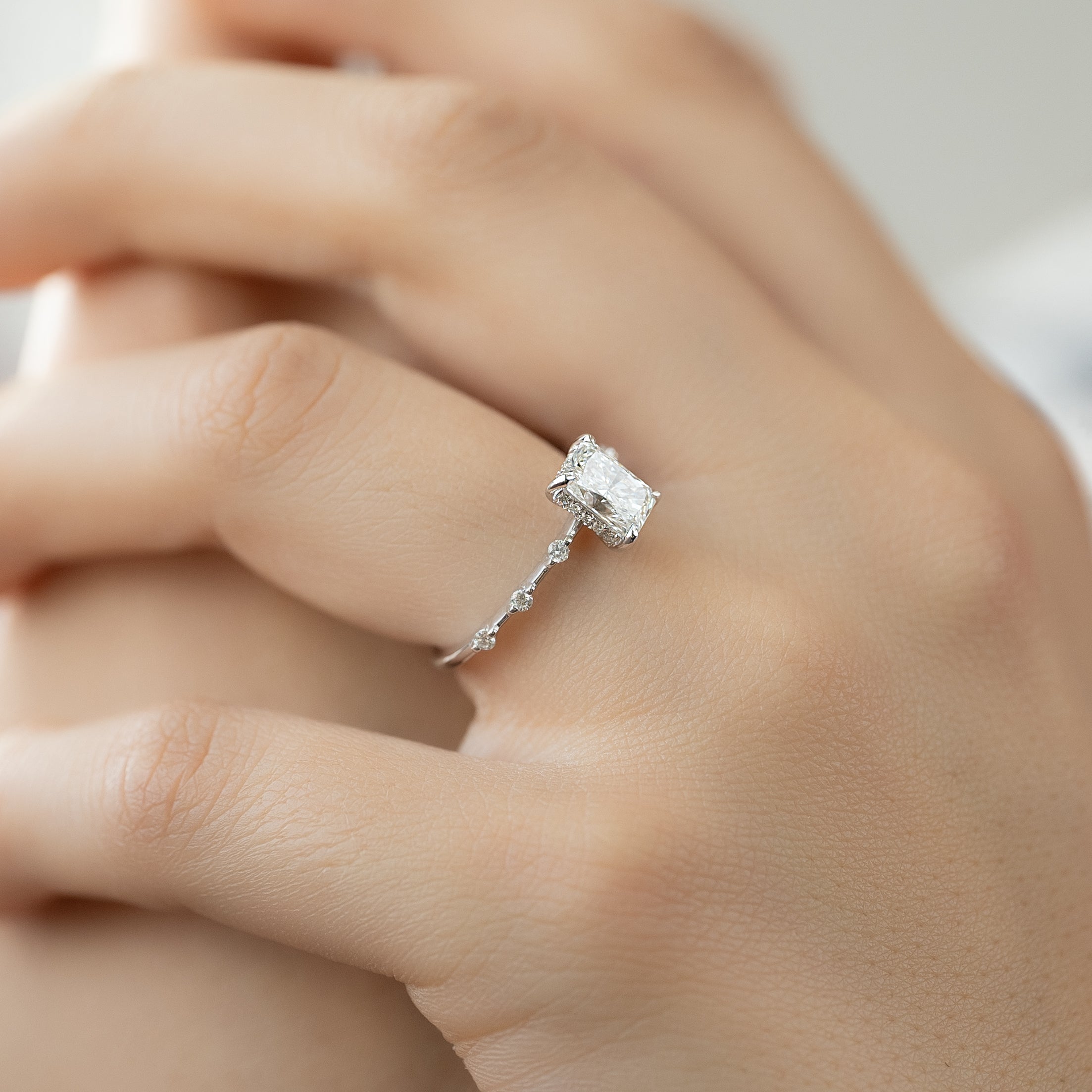 Radiant cut CVD diamond engagement ring with hidden halo in dainty platinum setting