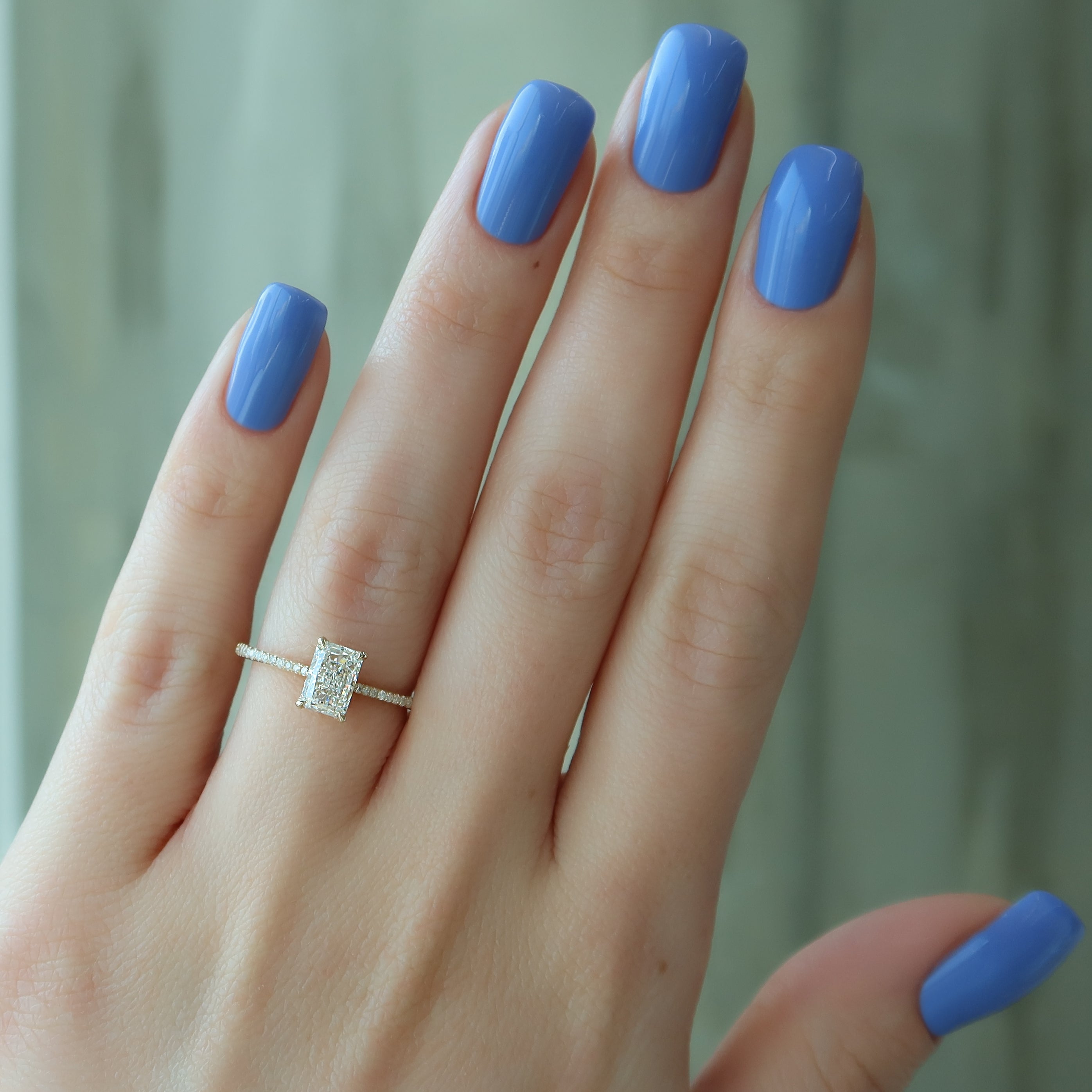 Radiant cut moissanite engagement ring with hidden halo and pave setting in platinum