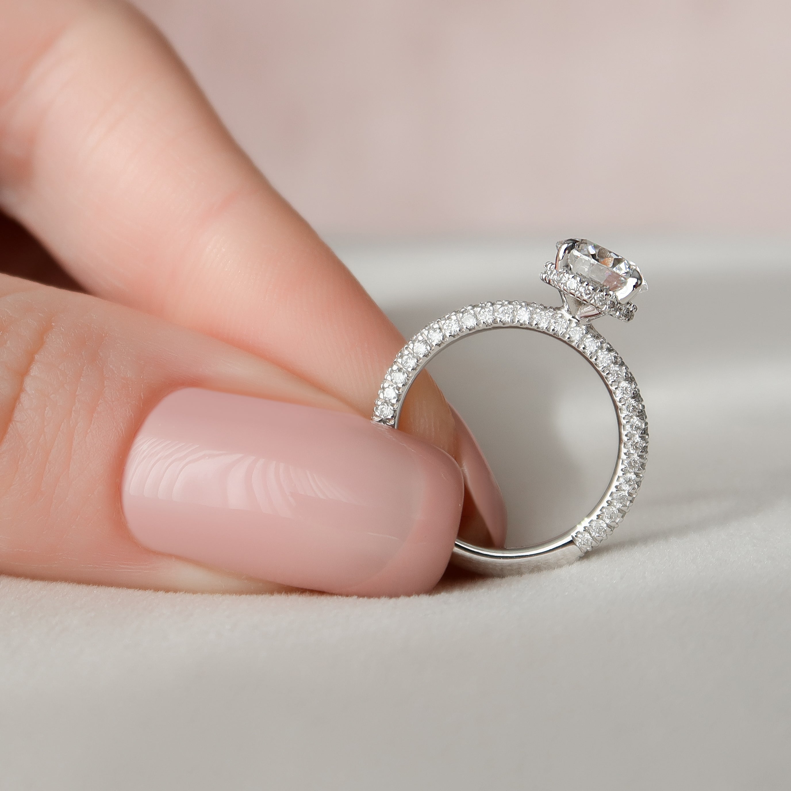 Round cut moissanite engagement ring with hidden halo and pave band in white gold setting