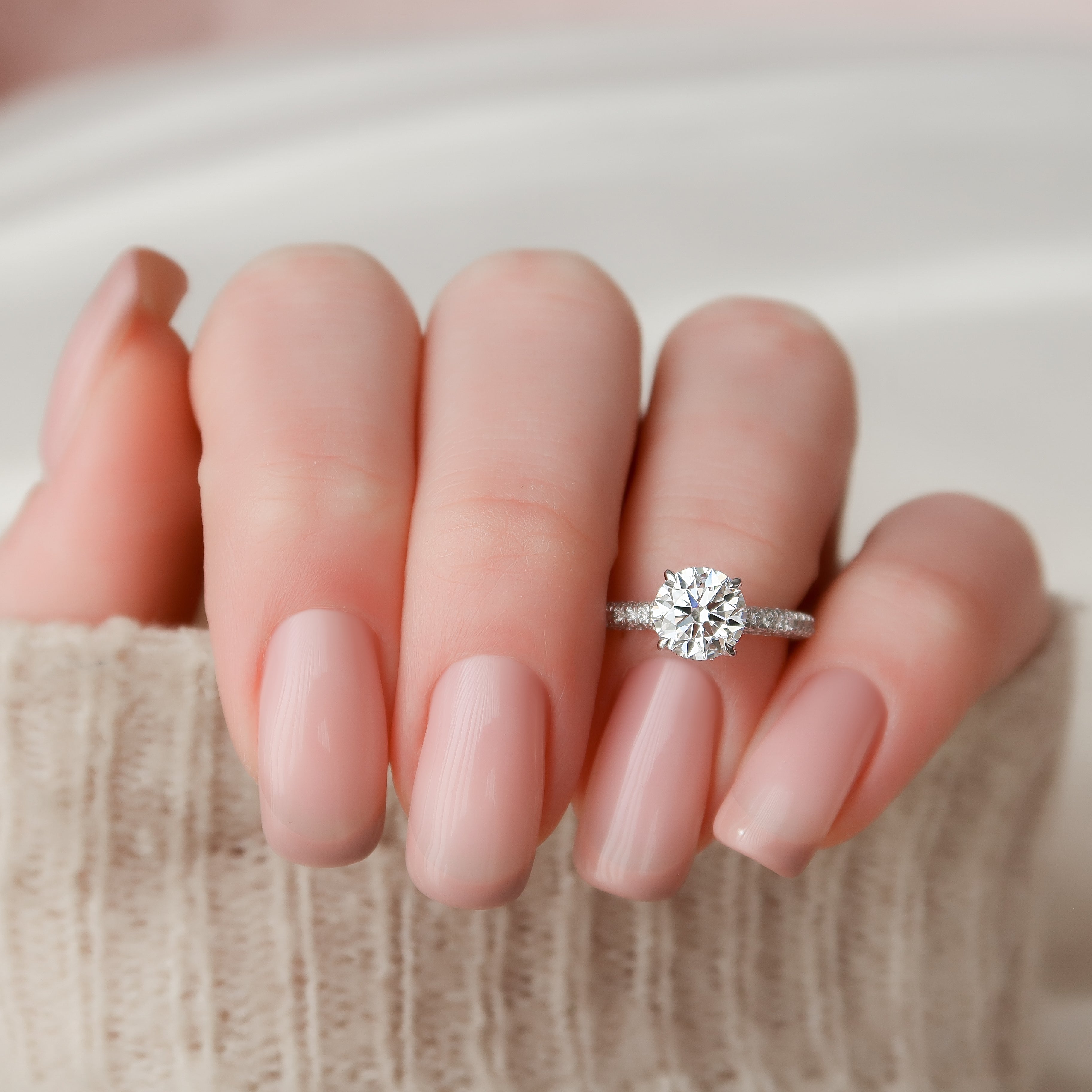 Round cut moissanite engagement ring with hidden halo and pave band in white gold setting