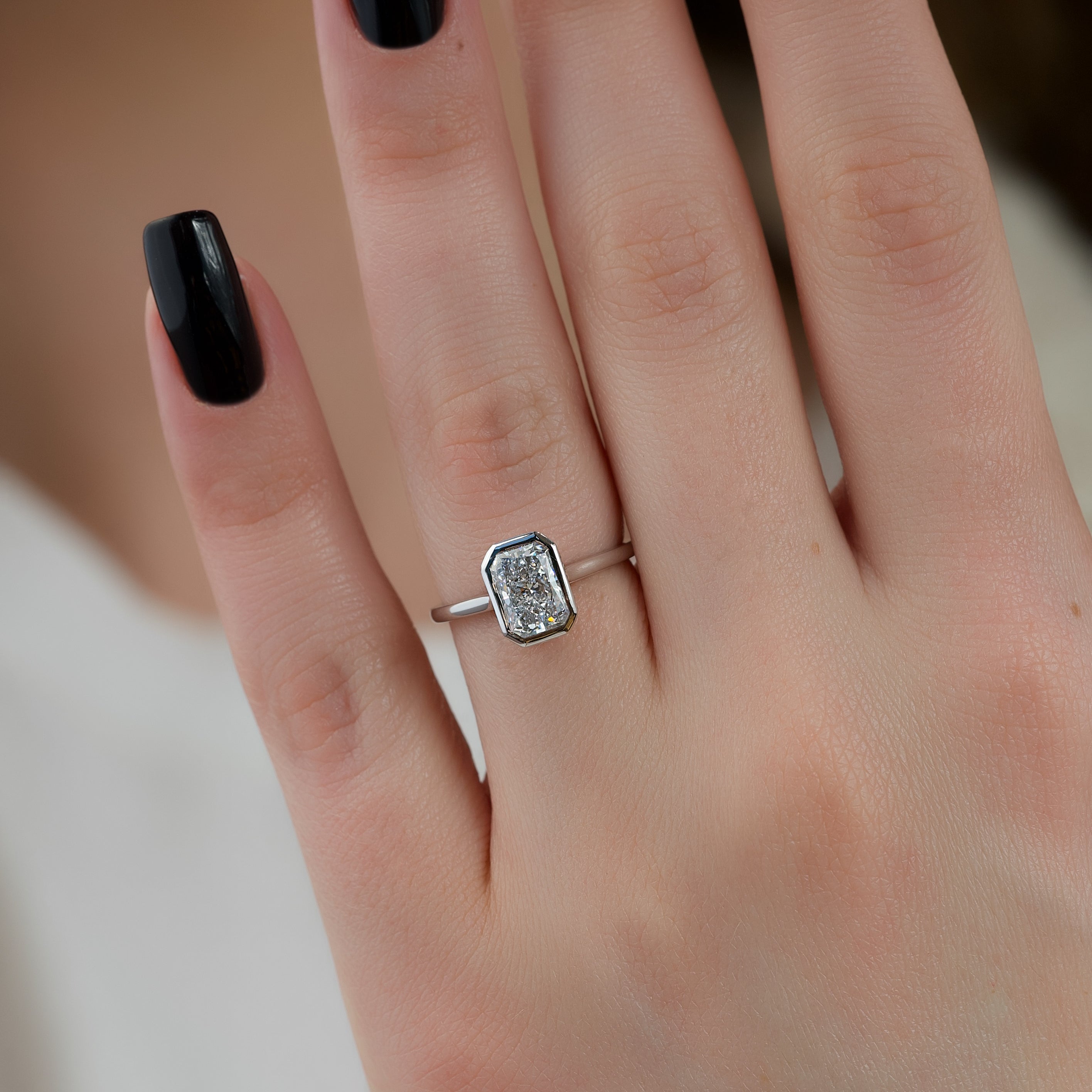 Radiant cut CVD diamond bezel set engagement ring with hidden halo in platinum setting