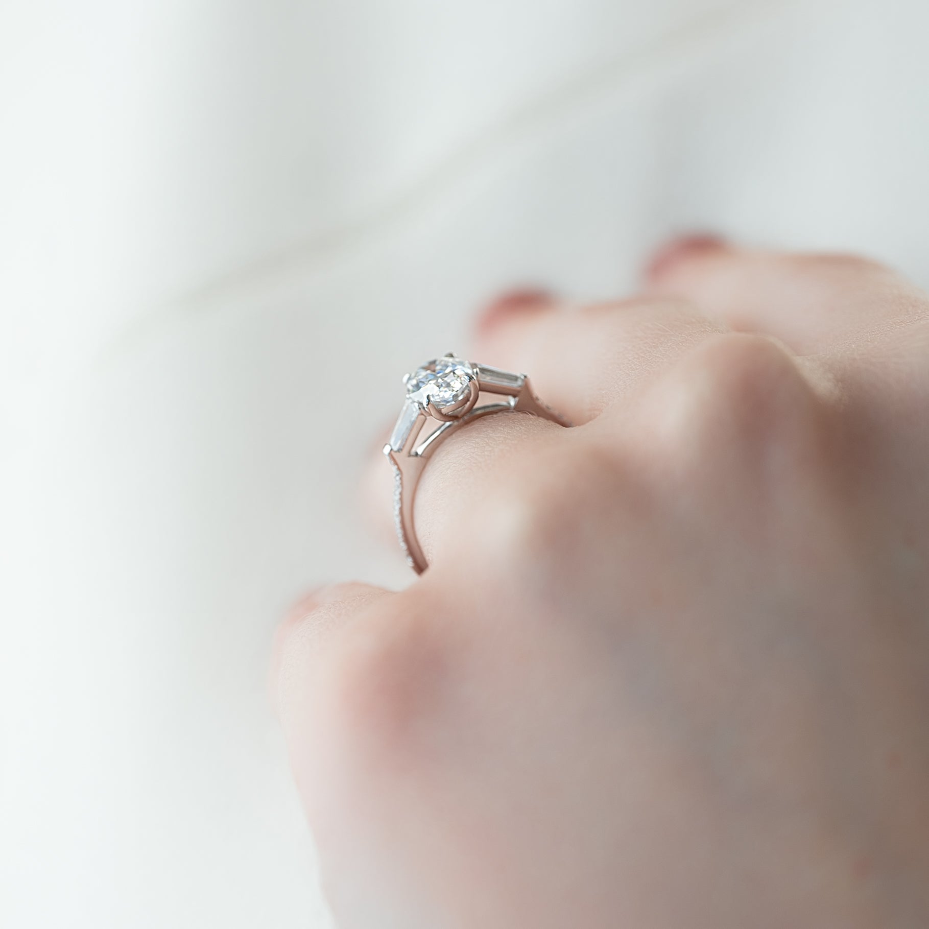Oval cut CVD diamond three stone engagement ring with side stones in white gold