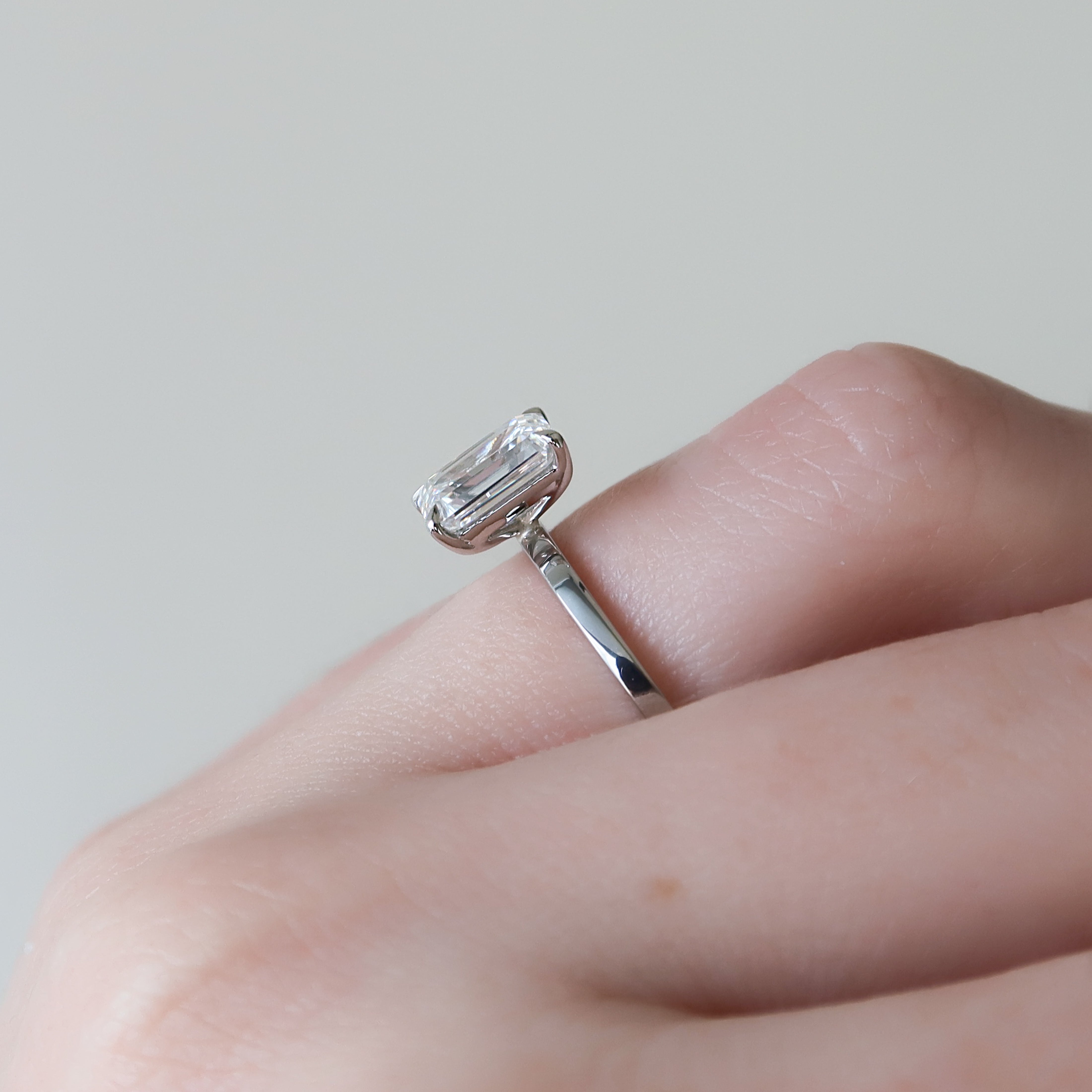 Emerald cut moissanite solitaire engagement ring in platinum setting