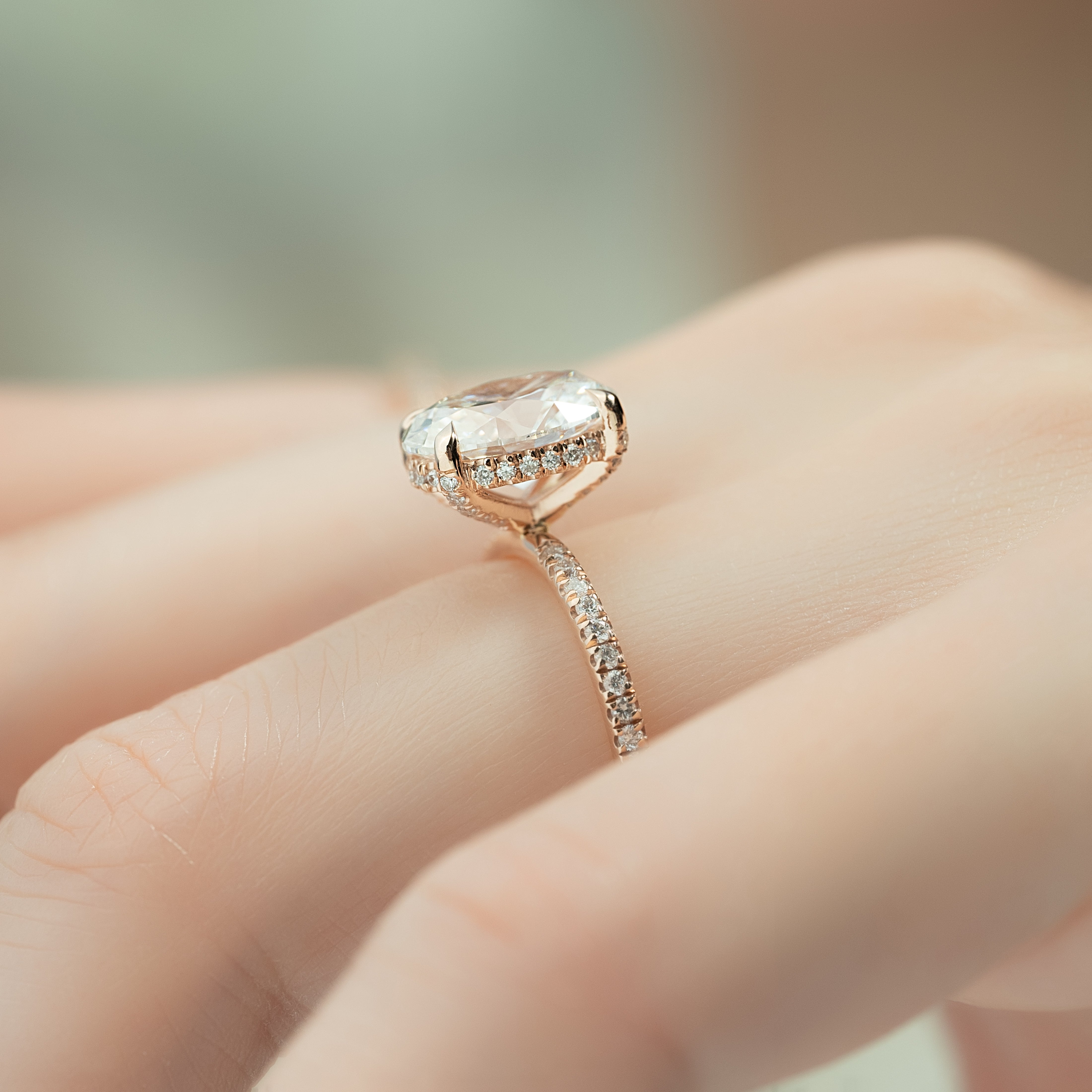 Oval cut CVD diamond engagement ring featuring hidden halo and pave band in platinum