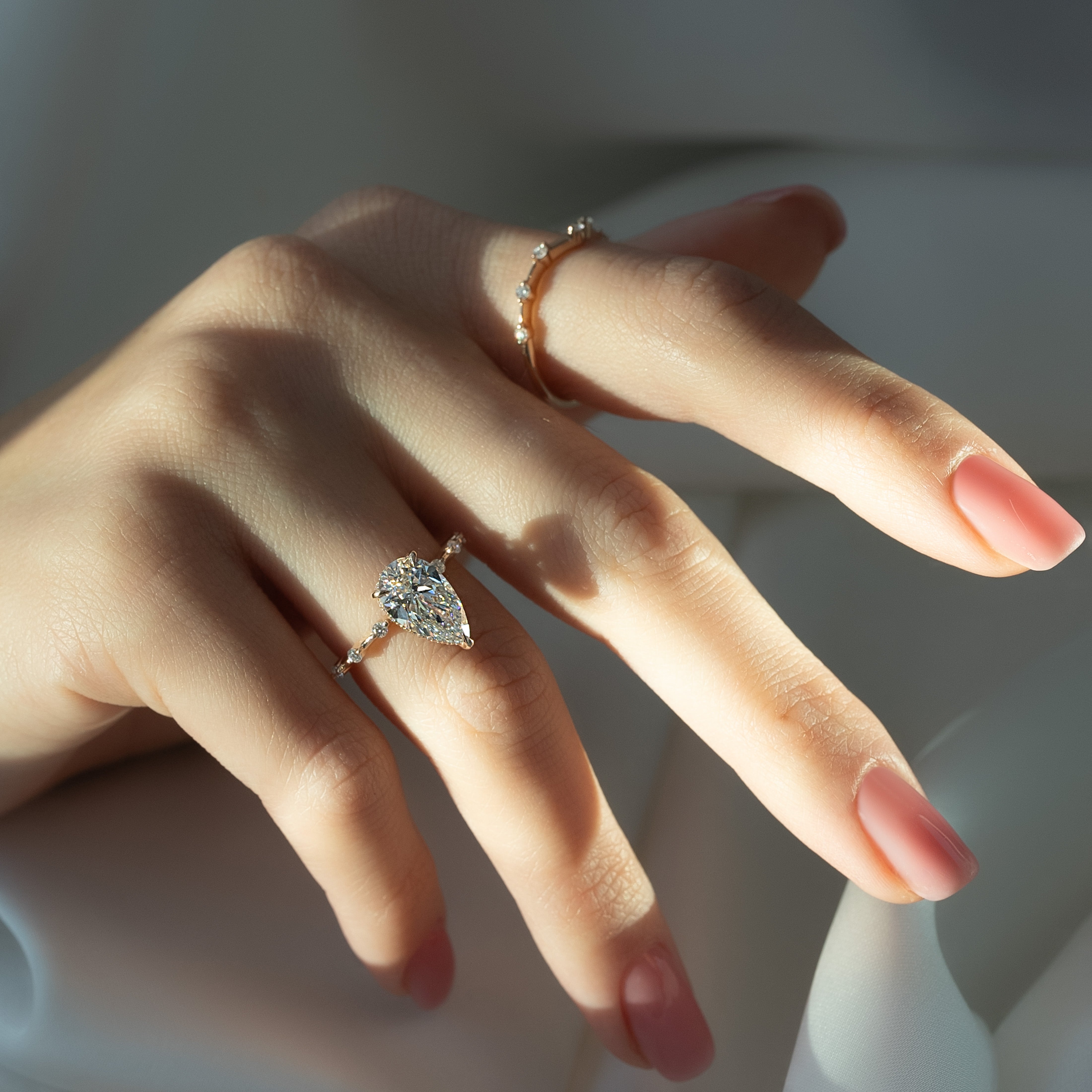 Pear cut CVD diamond engagement ring with hidden halo and dainty pave band in white gold