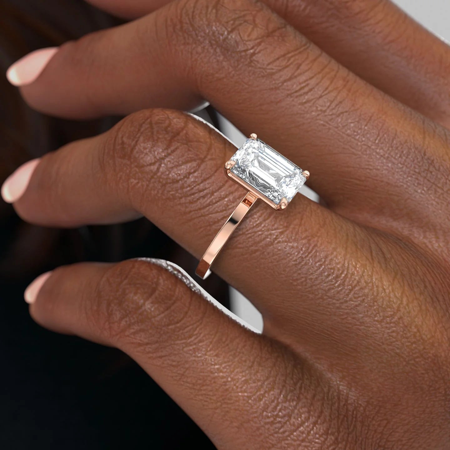 Emerald cut moissanite solitaire engagement ring in platinum setting