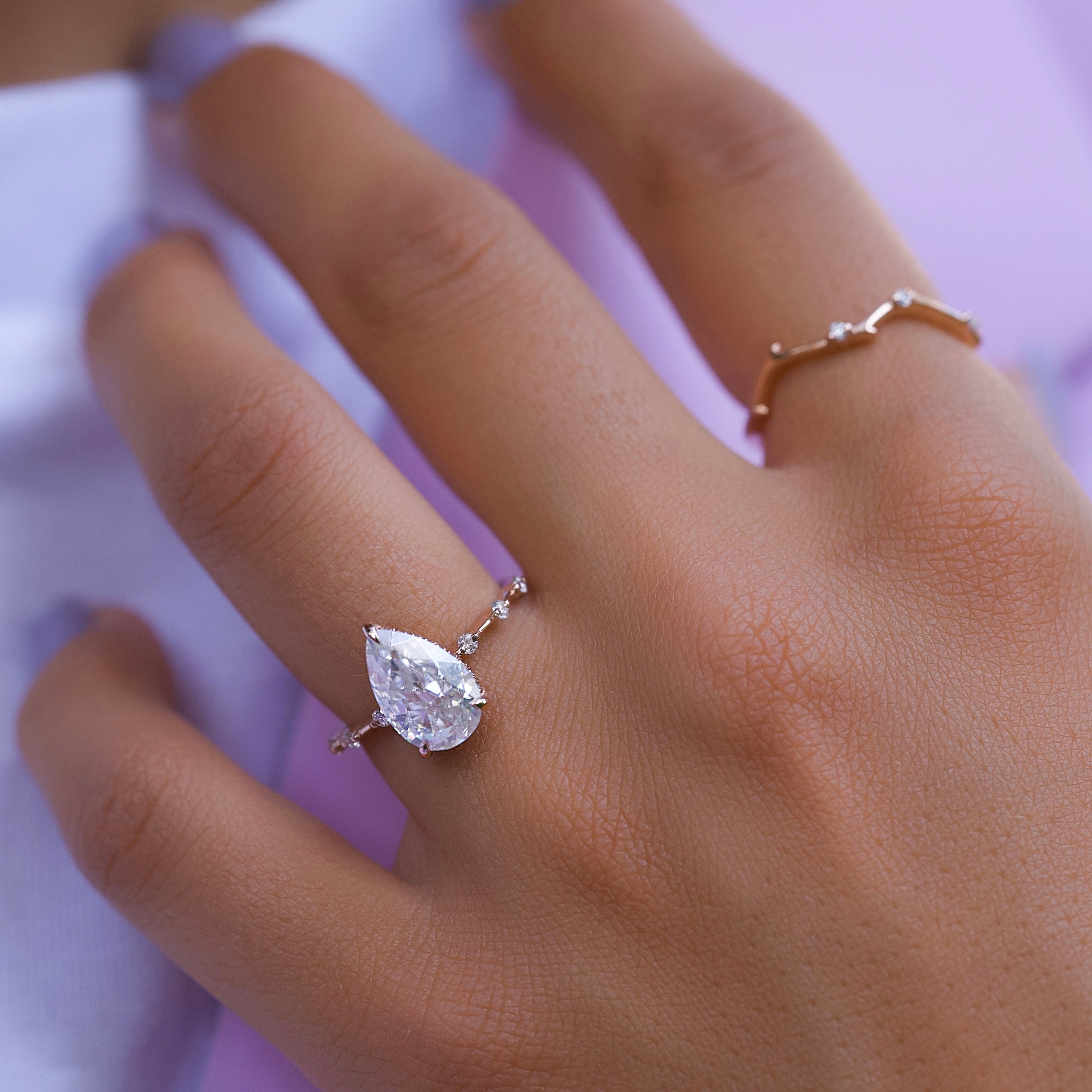 Pear cut CVD diamond engagement ring with hidden halo and dainty pave band in white gold
