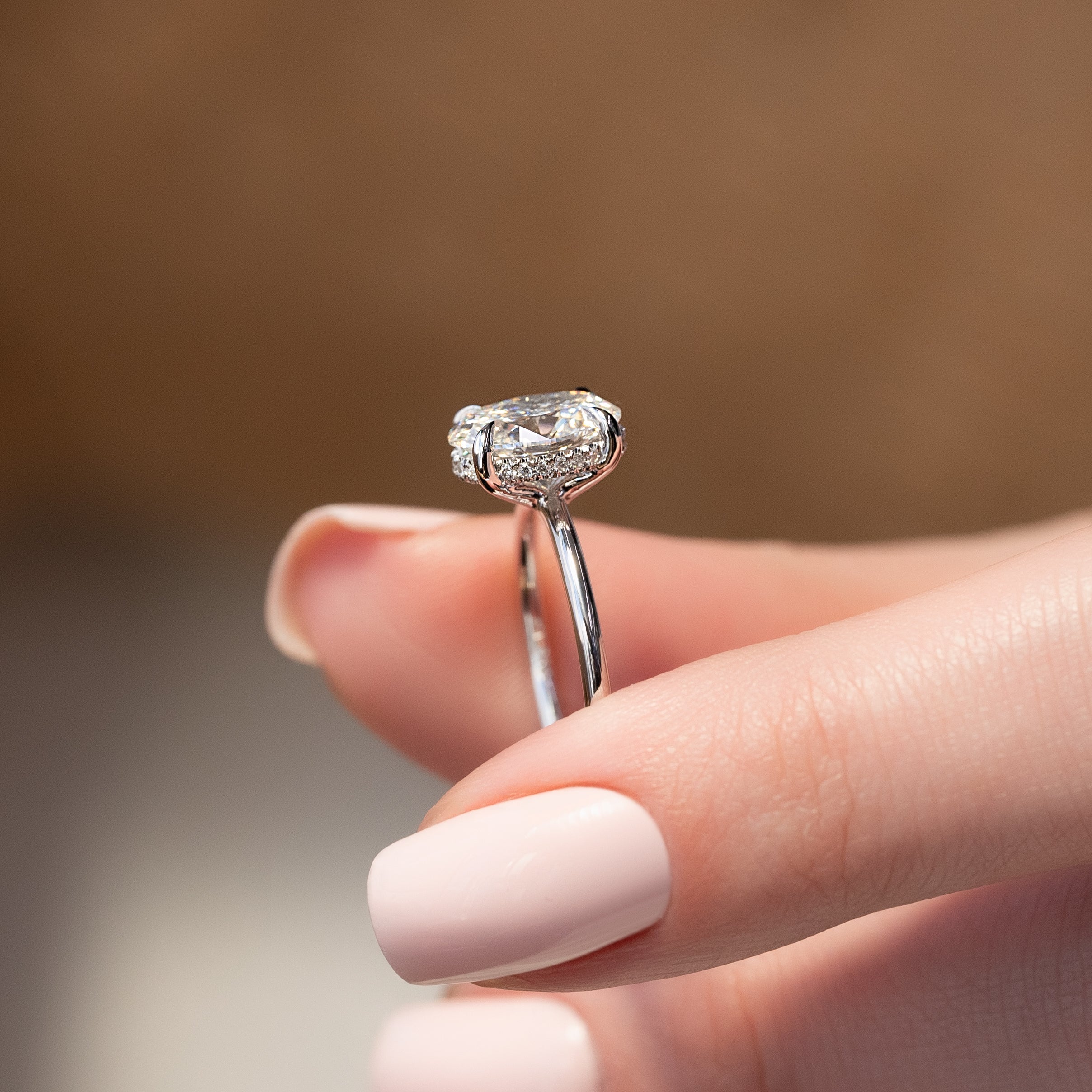 Oval cut CVD diamond hidden halo engagement ring with delicate band in white gold