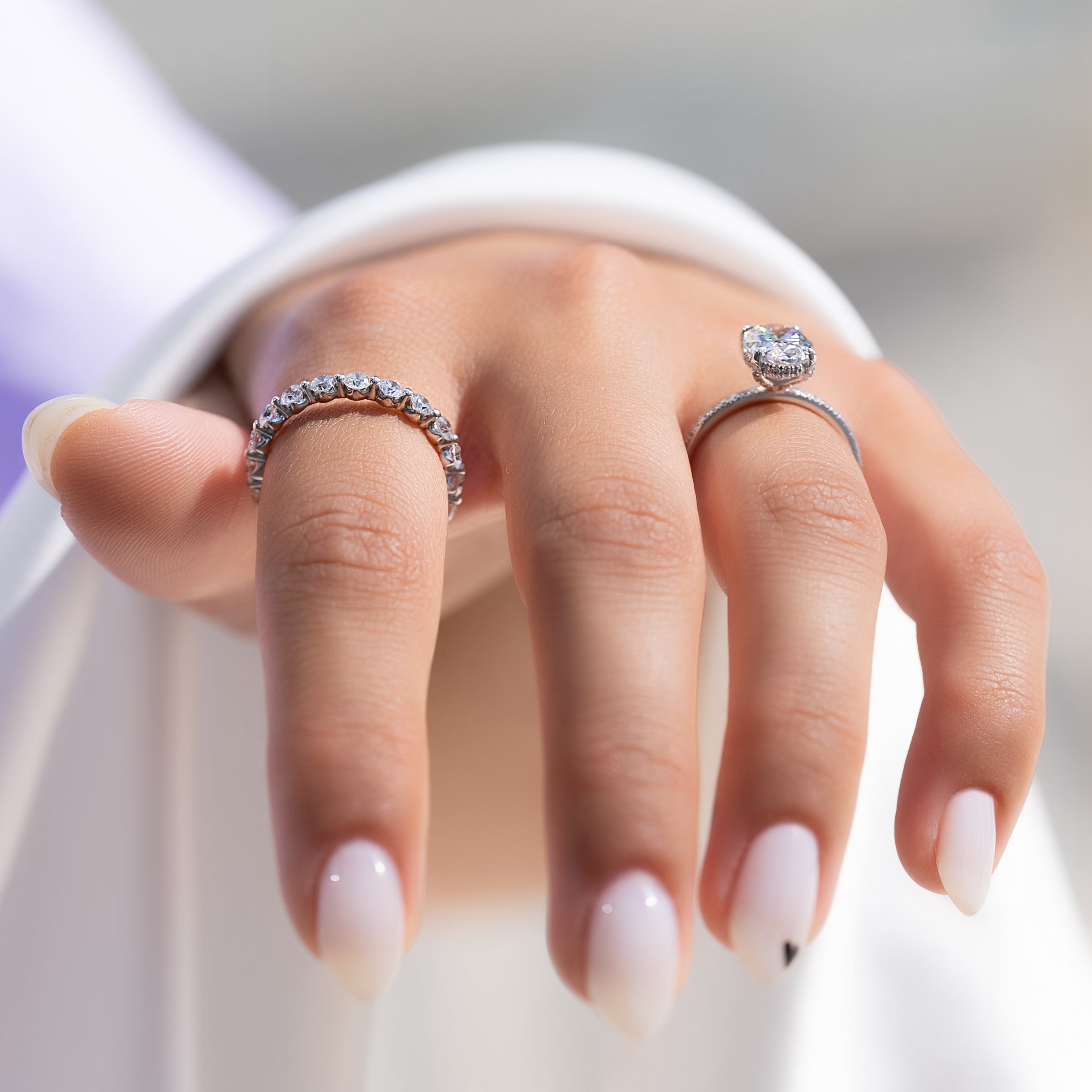 Oval cut CVD diamond engagement ring featuring hidden halo and pave band in platinum
