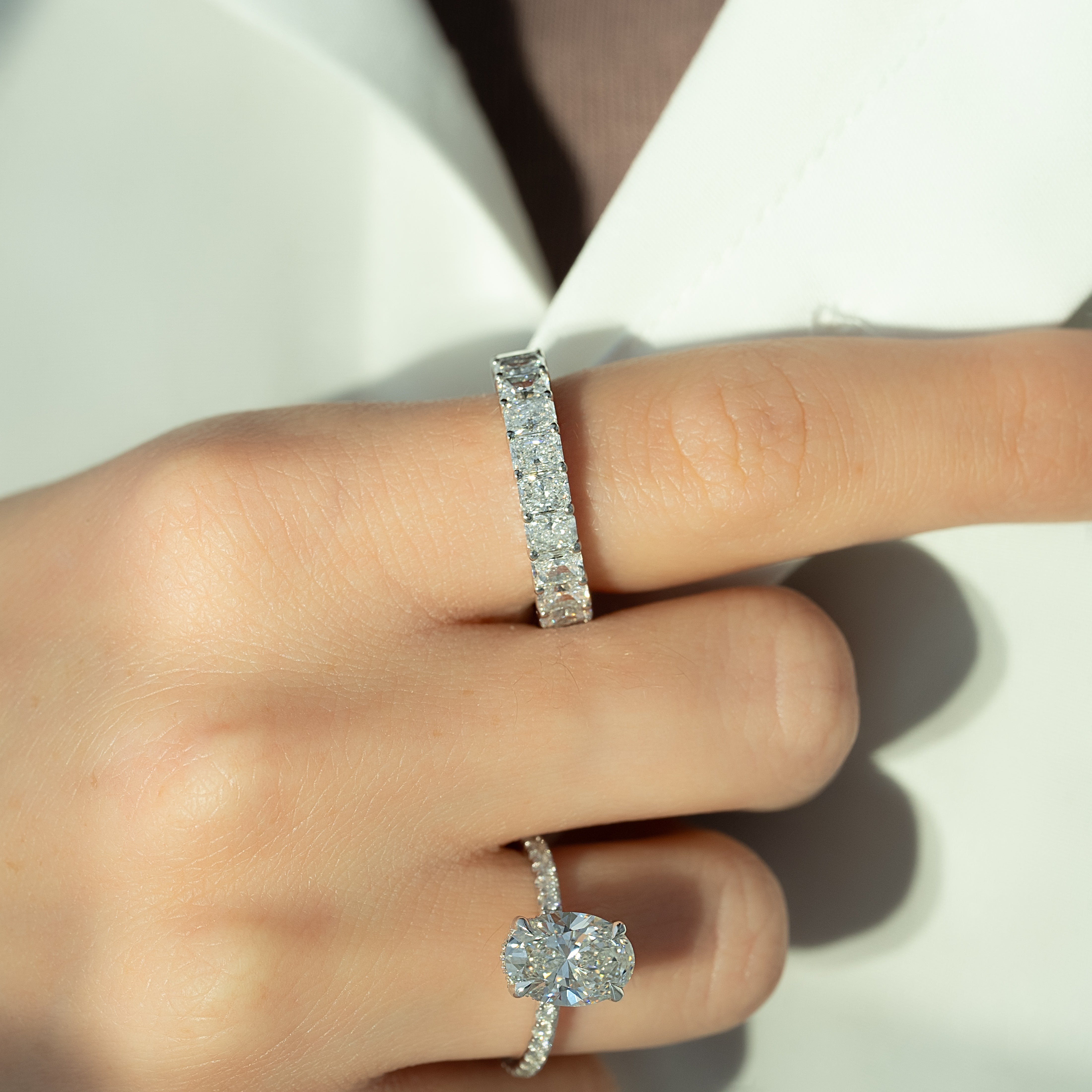 Oval cut CVD diamond engagement ring featuring hidden halo and pave band in platinum