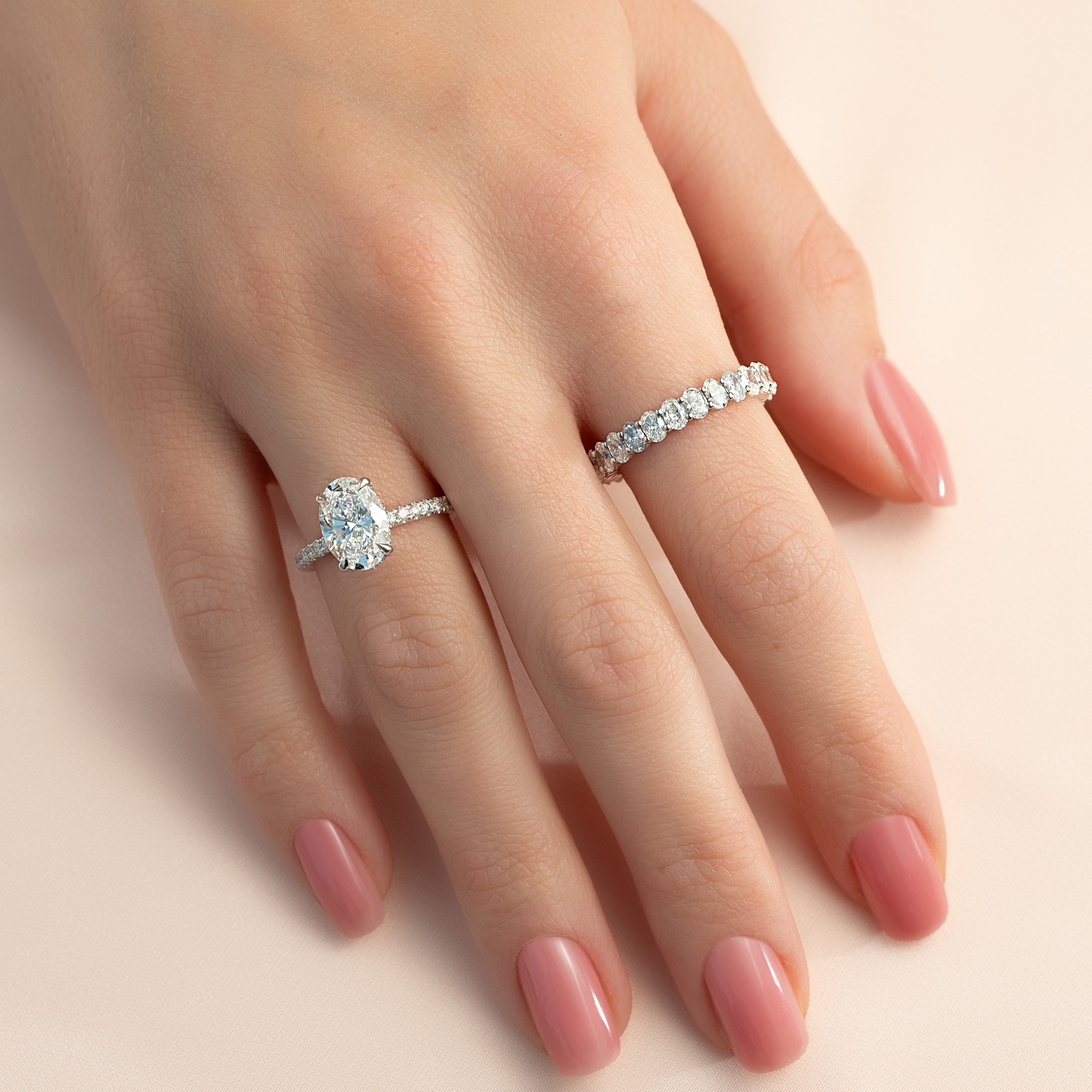 Oval cut CVD diamond engagement ring featuring hidden halo and pave band in platinum