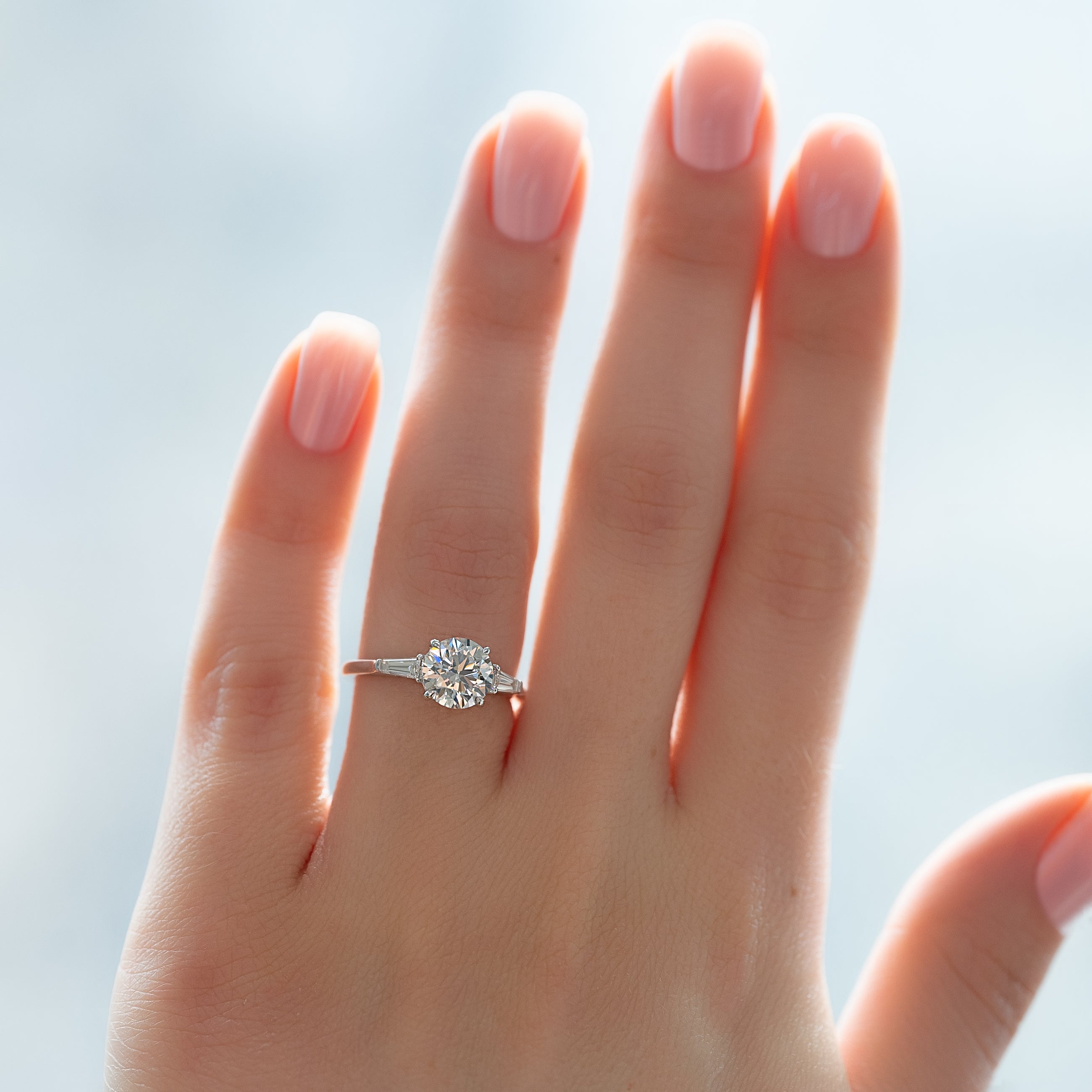 Round cut CVD diamond three stone engagement ring in platinum band