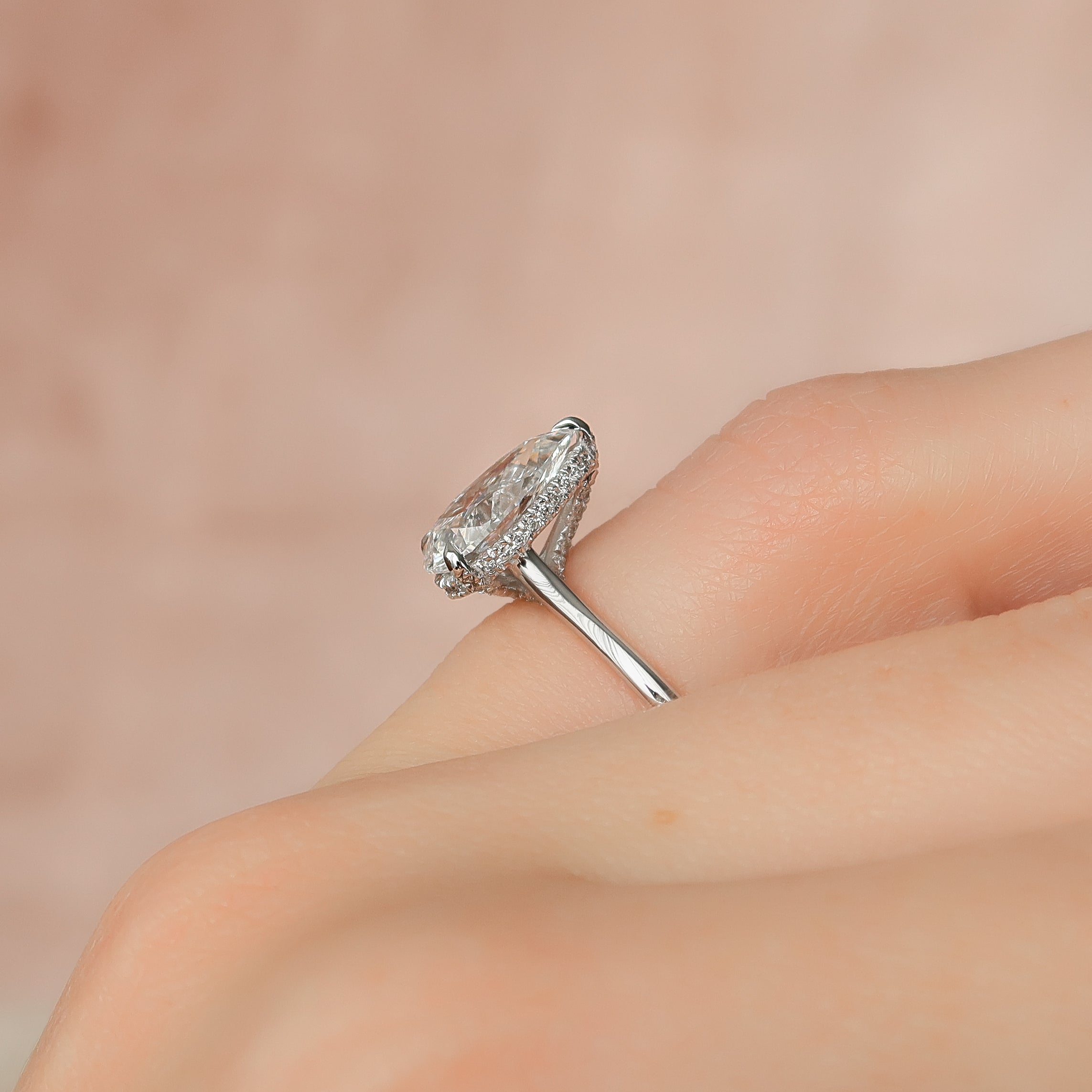 Pear cut CVD diamond engagement ring with hidden halo in white gold setting
