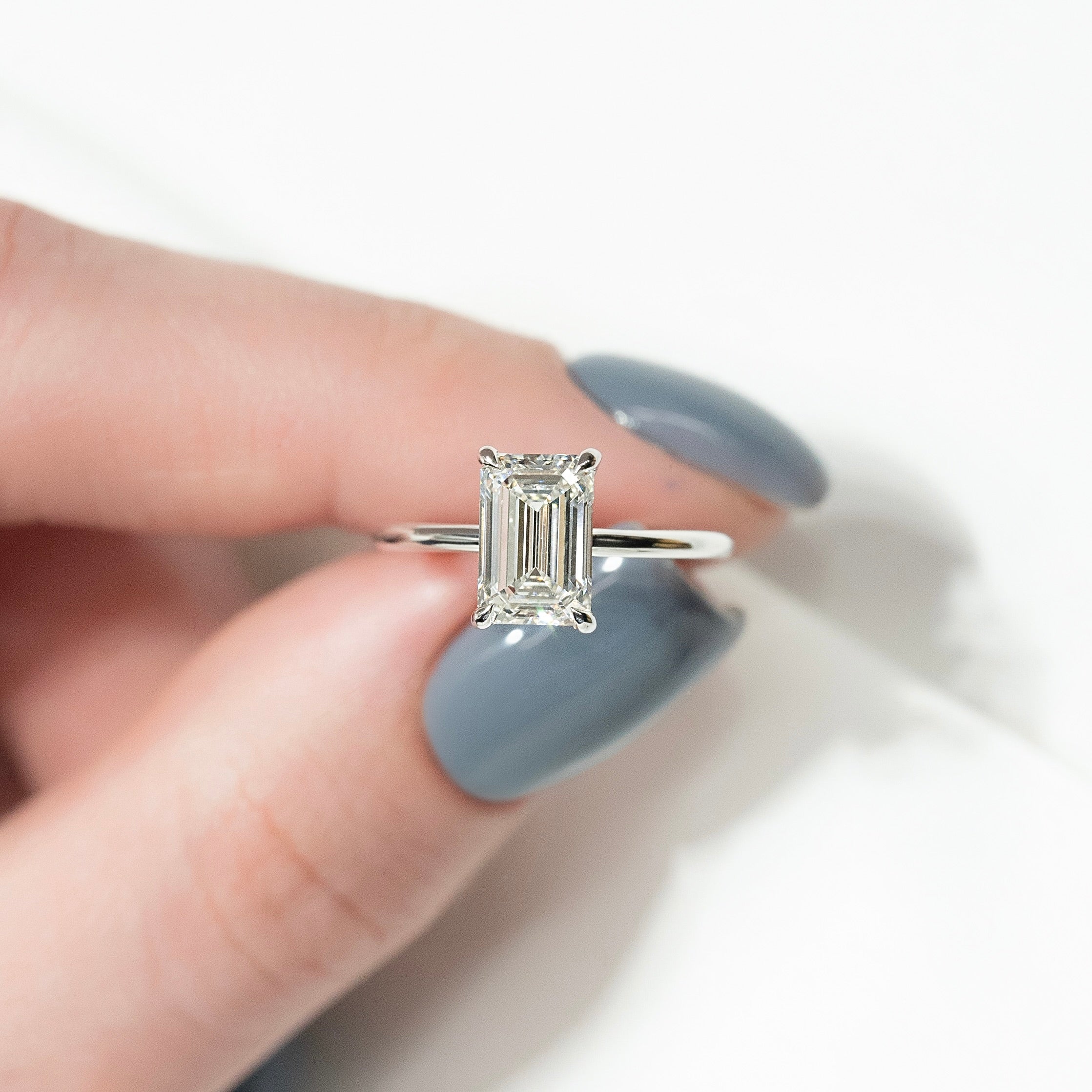Emerald cut CVD diamond solitaire engagement ring in platinum setting