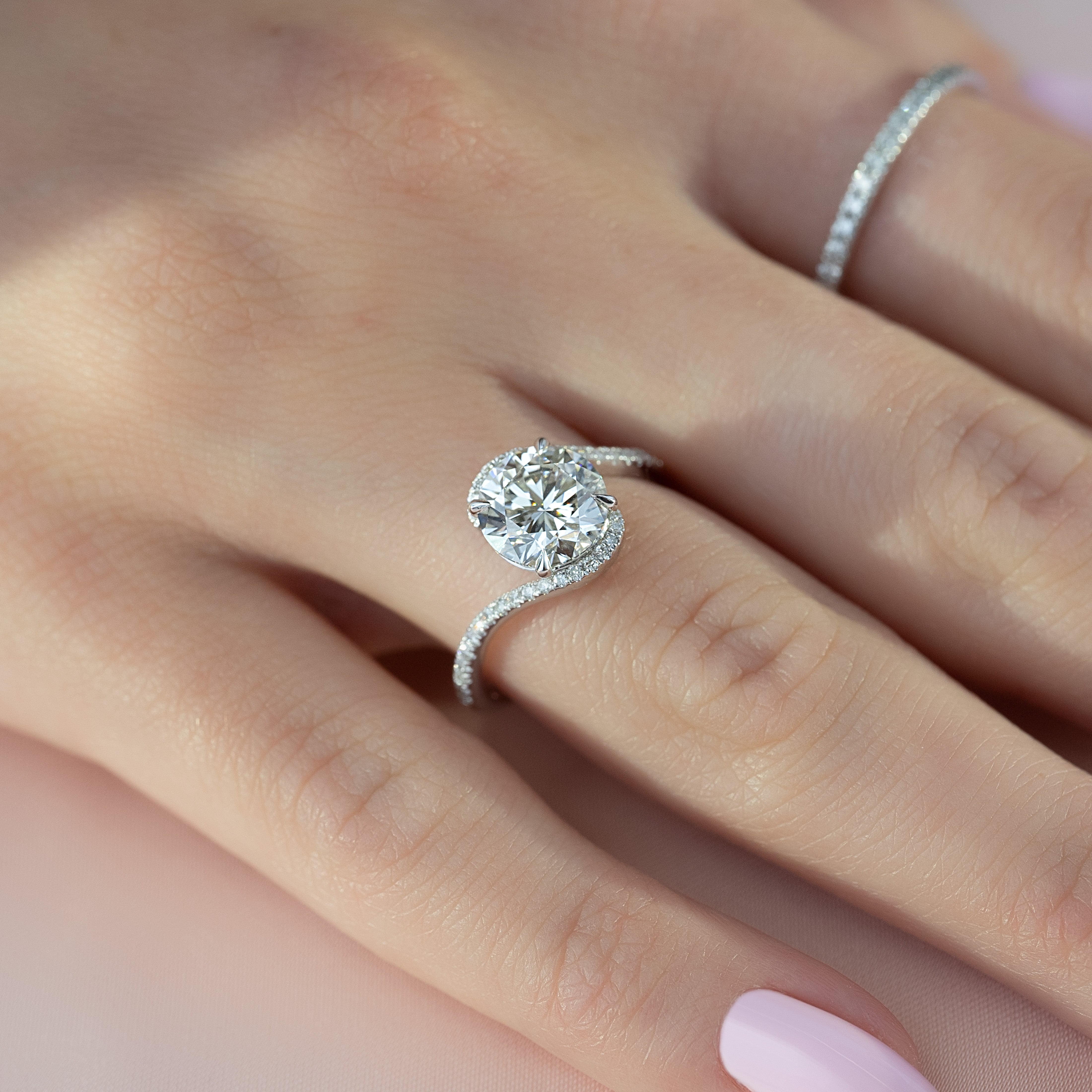 Round cut moissanite engagement ring in bypass setting with white gold band