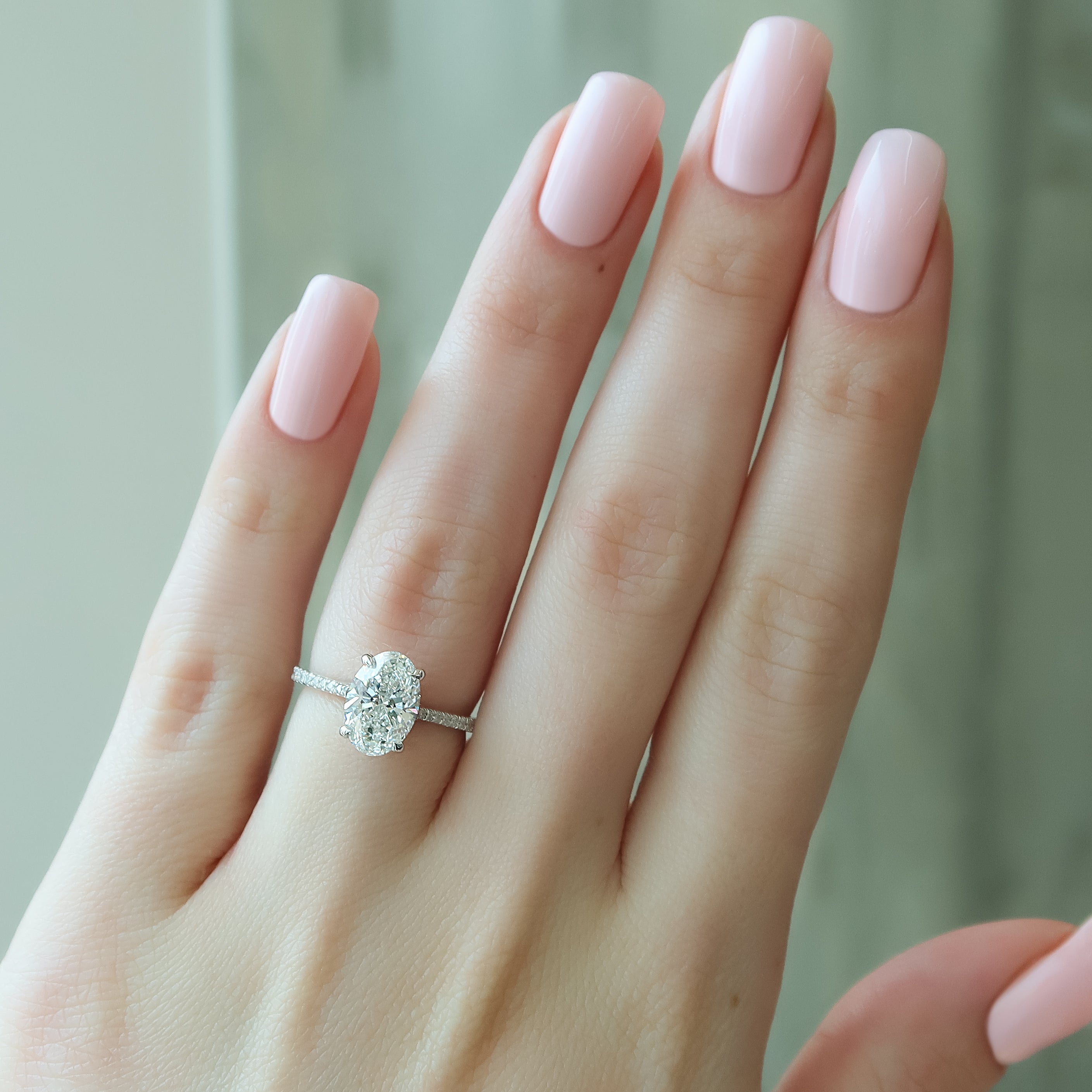 Oval cut CVD diamond engagement ring with pave diamond band in platinum setting