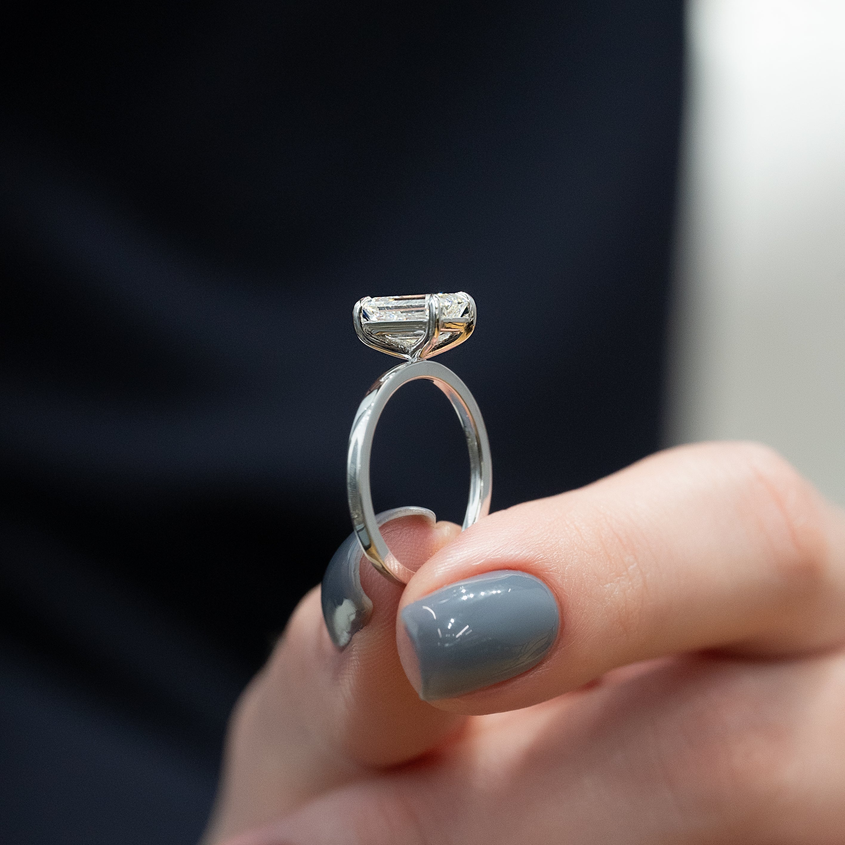 Emerald cut moissanite solitaire engagement ring in platinum setting