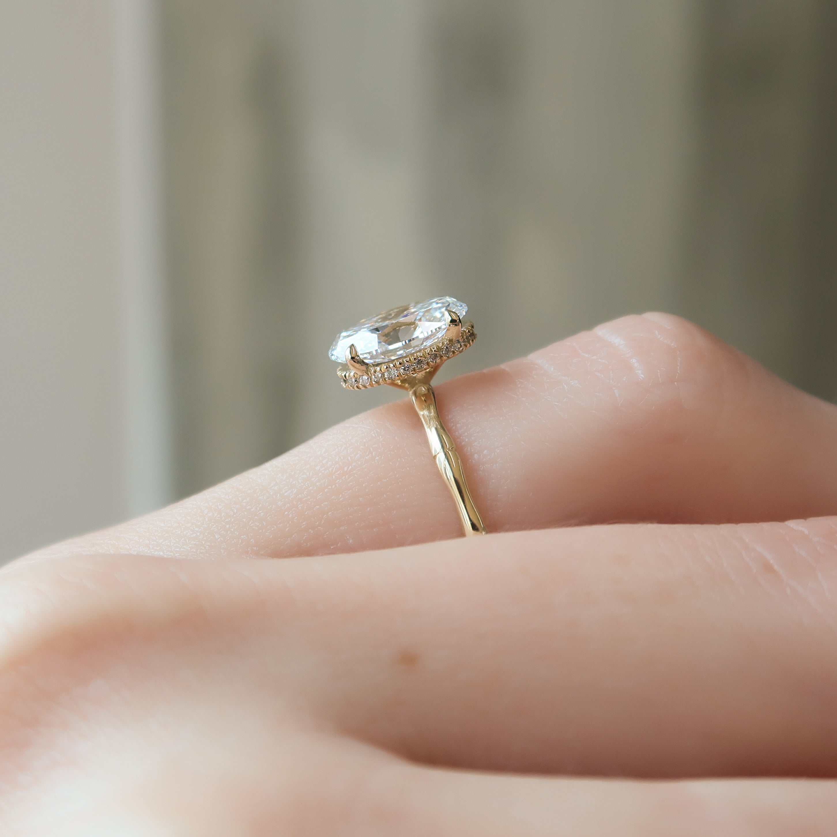 Oval cut CVD diamond engagement ring with hidden halo detail in platinum setting