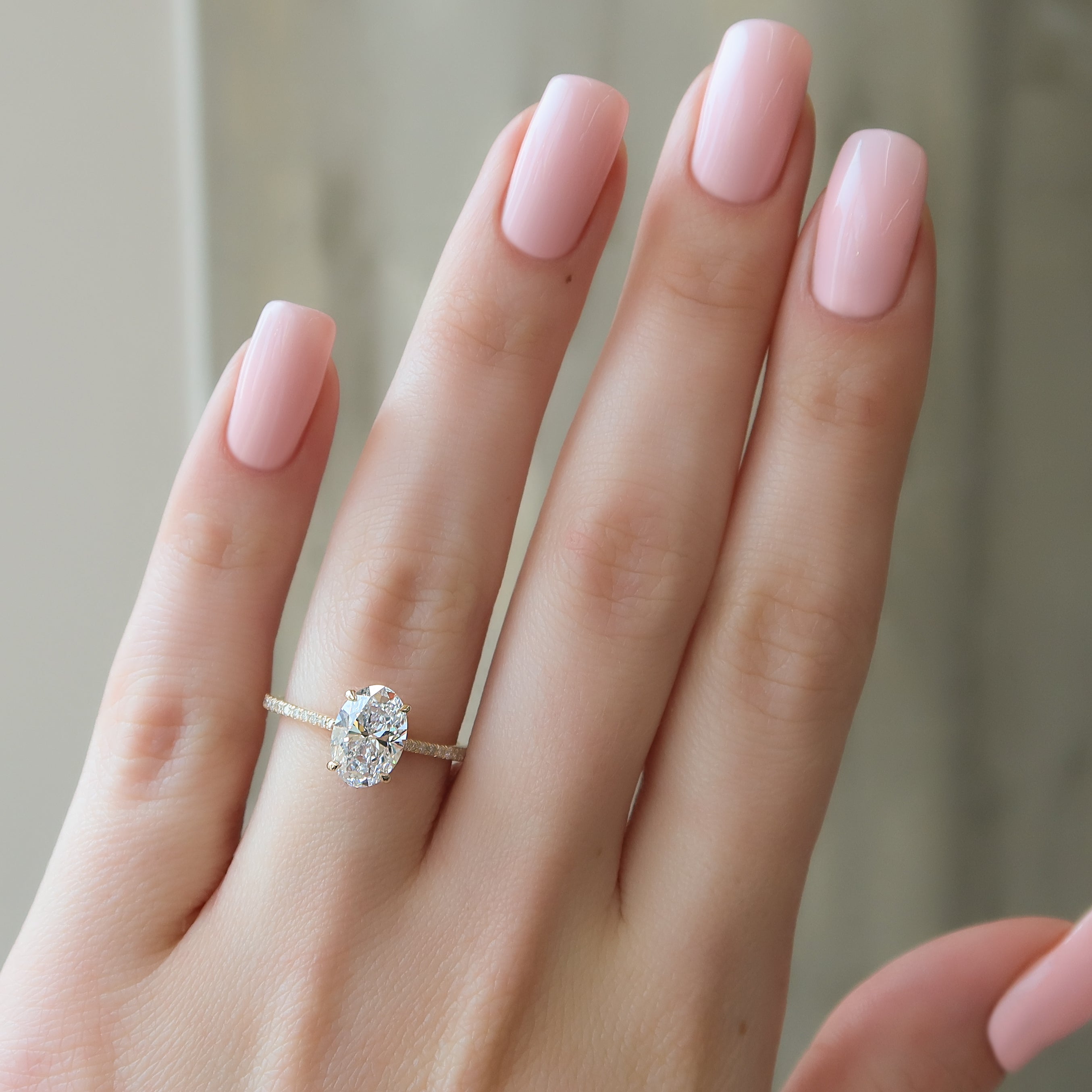 Oval cut CVD diamond engagement ring with pave diamond band in platinum setting