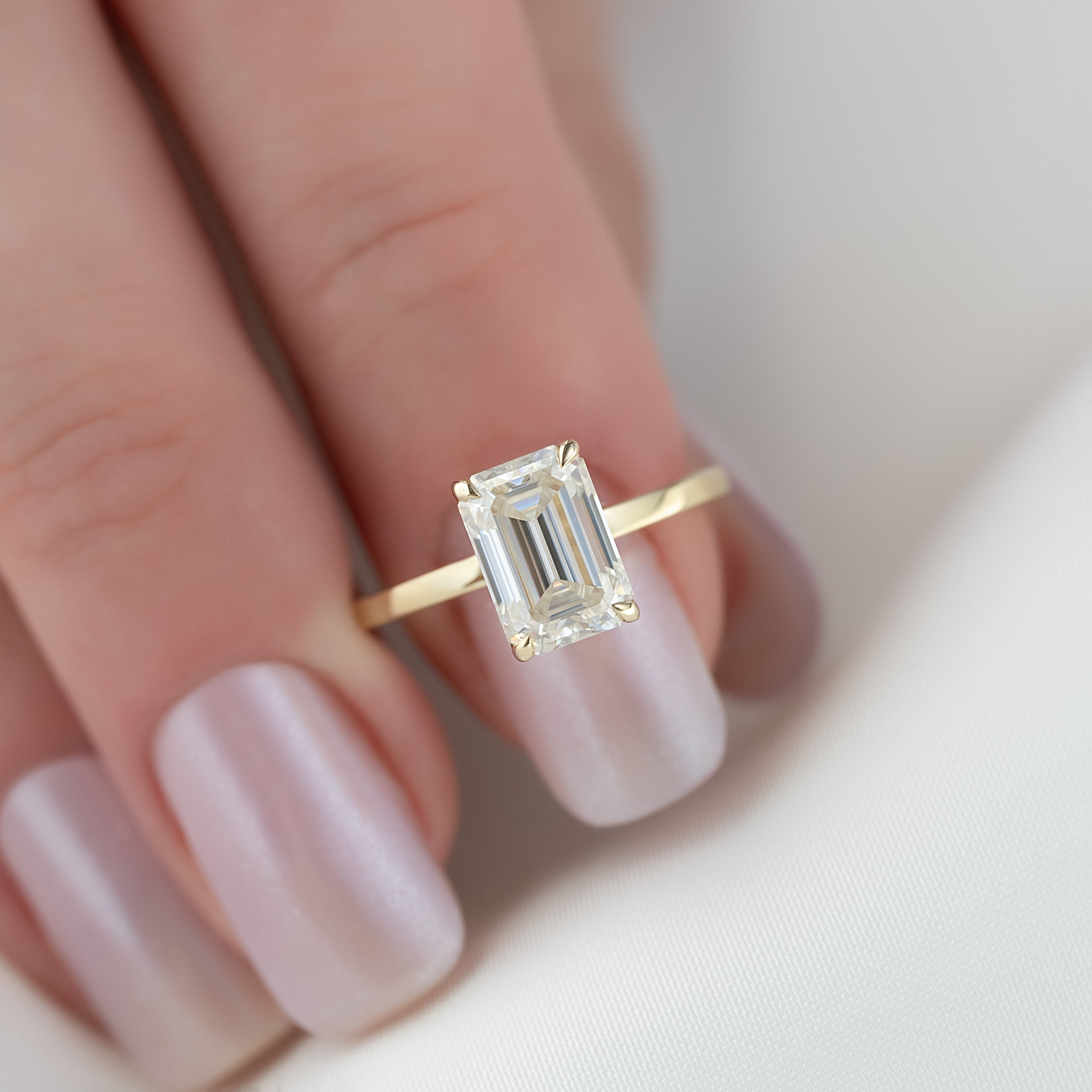 Emerald cut moissanite solitaire engagement ring in platinum setting
