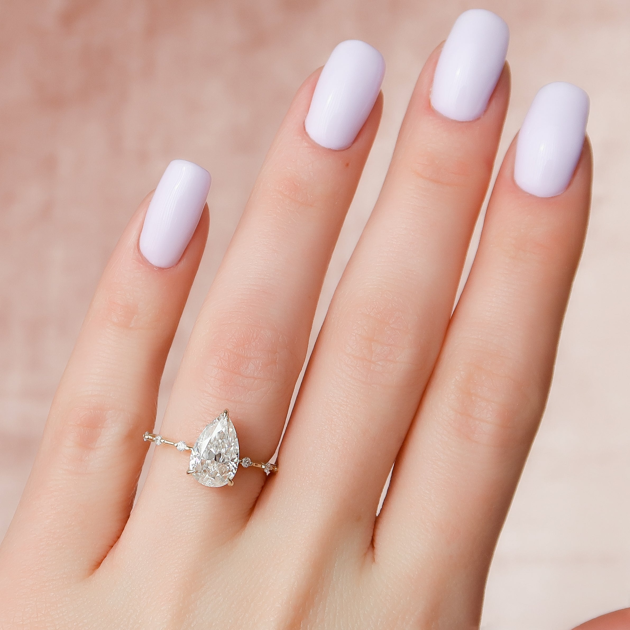 Pear cut CVD diamond engagement ring with hidden halo and dainty pave band in white gold