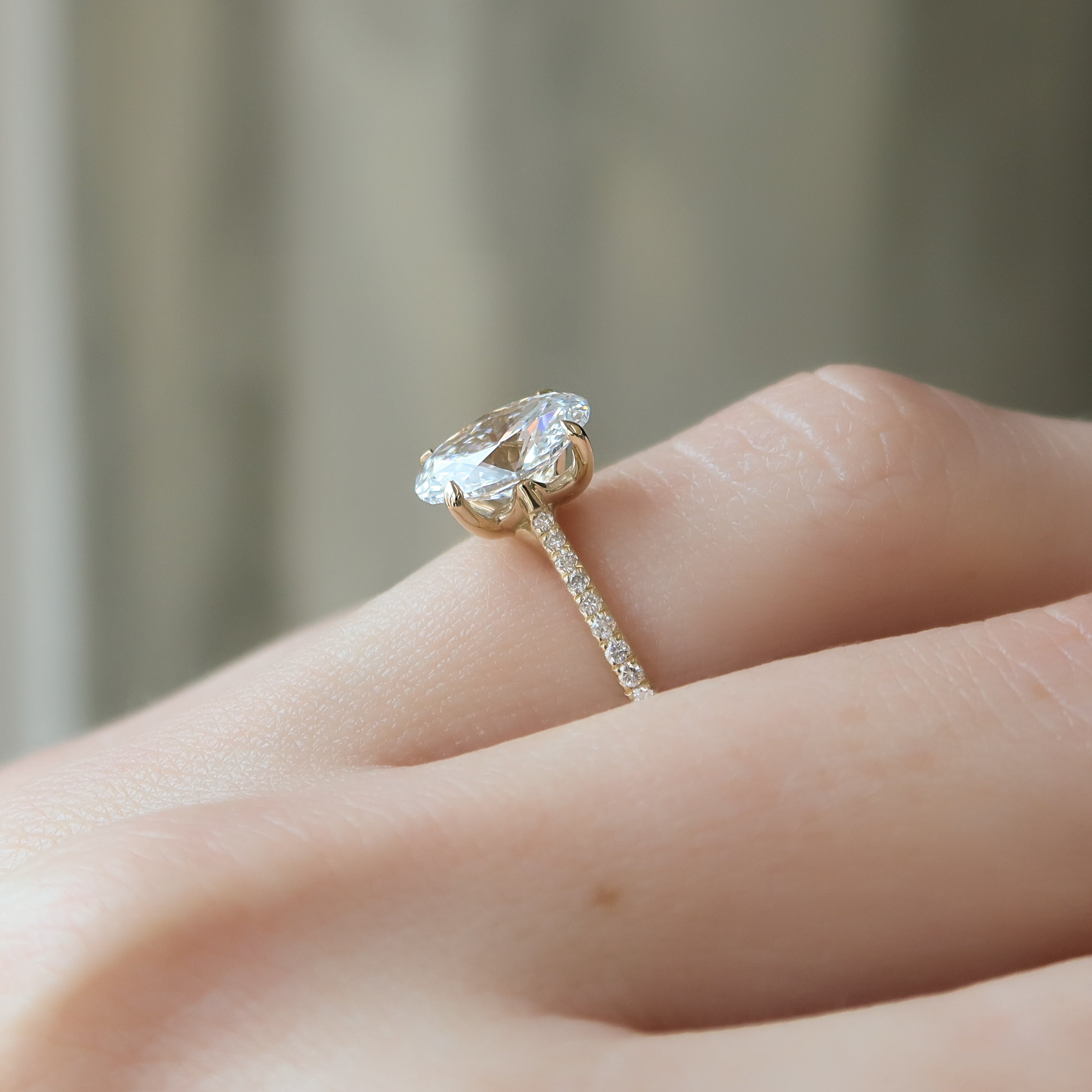 Oval cut CVD diamond engagement ring with pave diamond band in platinum setting