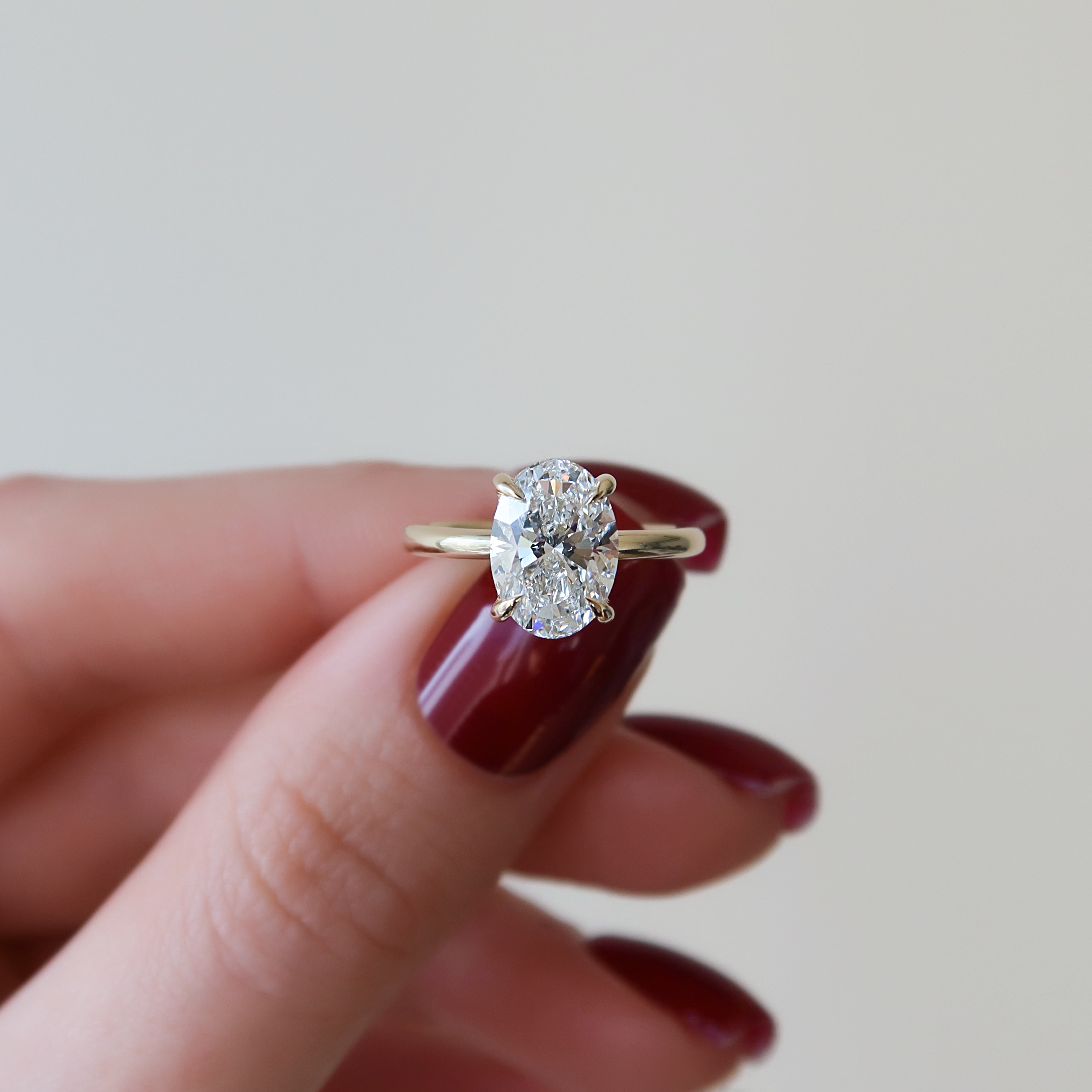 Oval cut CVD diamond hidden halo engagement ring with delicate band in white gold