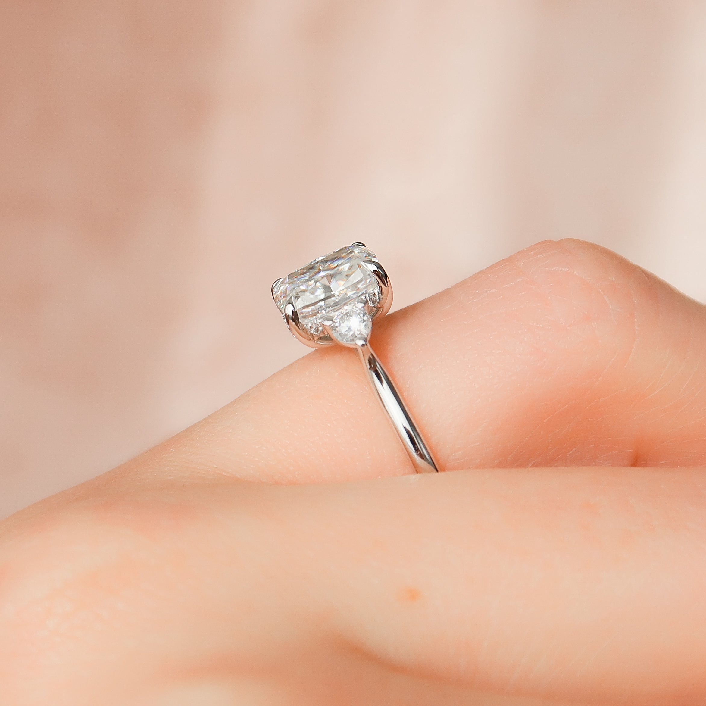 Elongated cushion cut CVD diamond three stone engagement ring in white gold