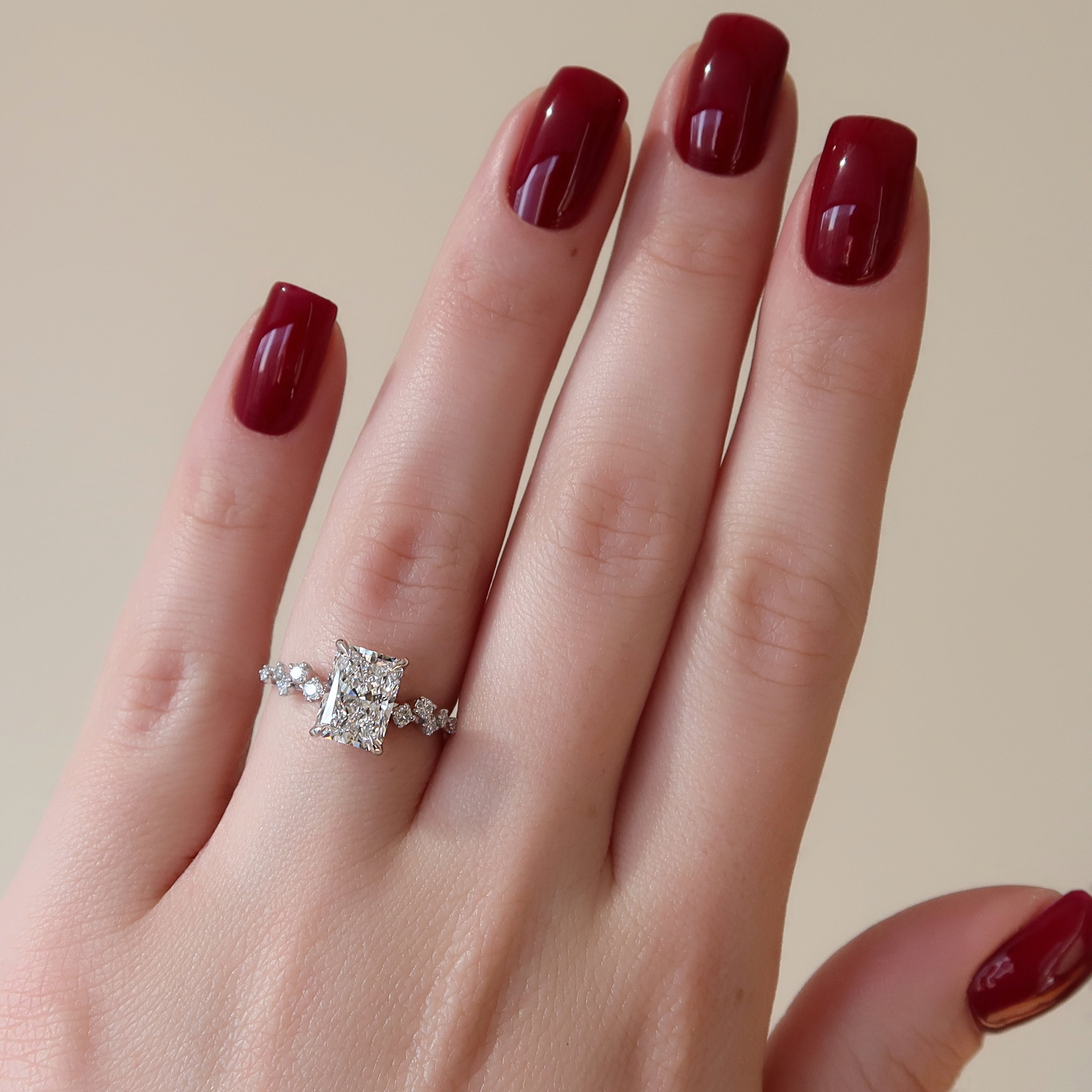 Radiant cut CVD diamond engagement ring with hidden halo and clustered diamond detailing in white gold