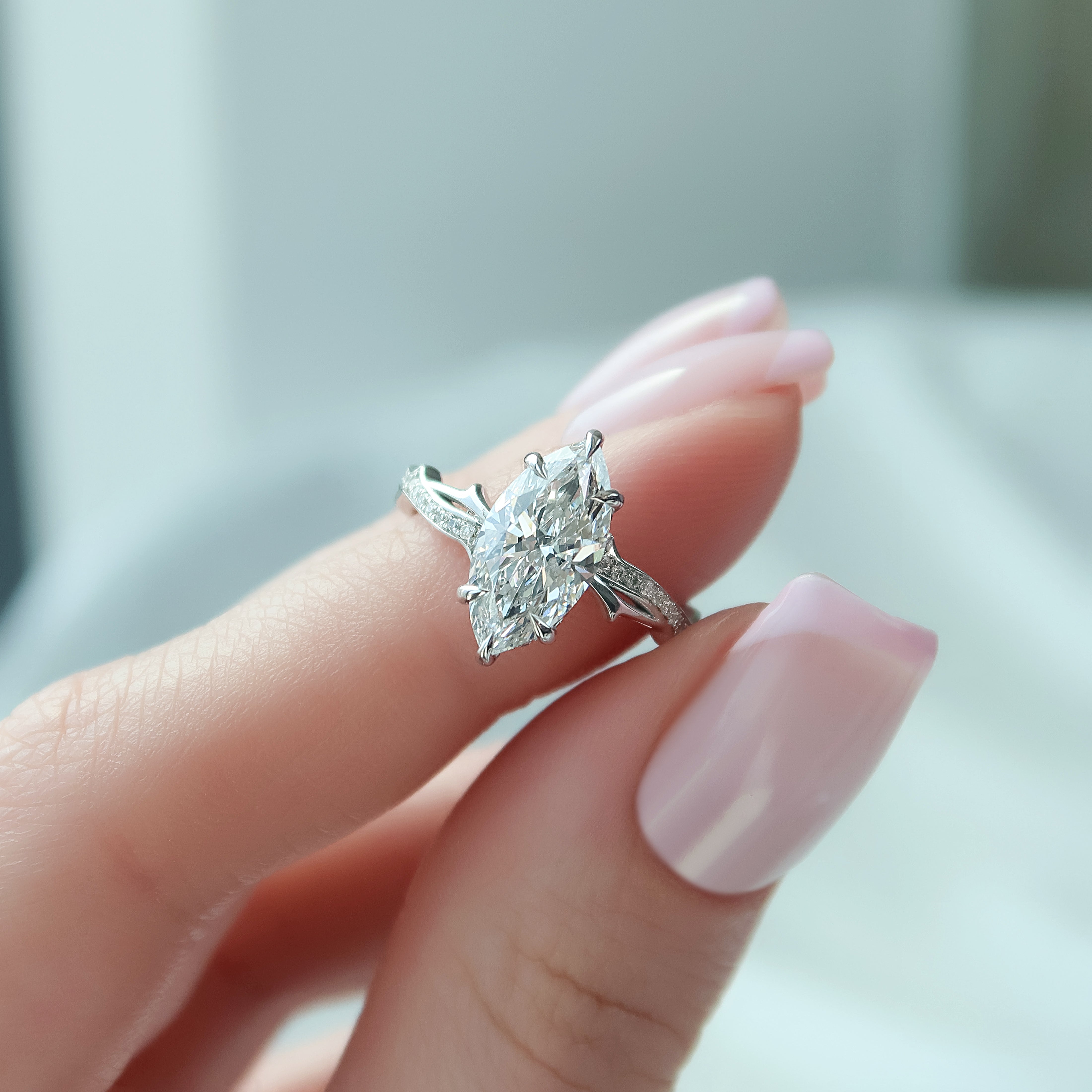 3.6 carat emerald and oval cut moissanite two-stone engagement ring in white gold setting with brilliant sparkle