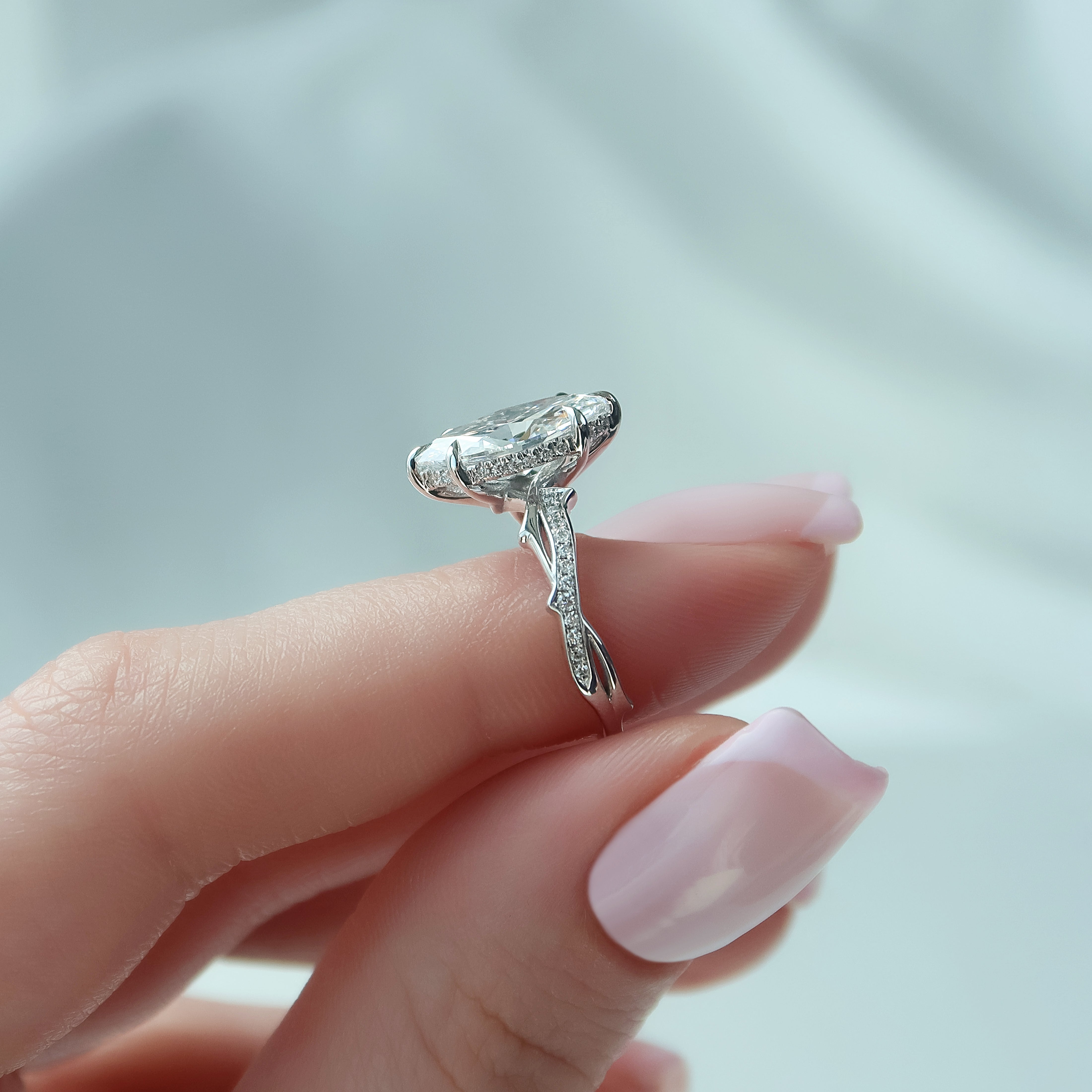 3.6 carat emerald and oval cut moissanite two-stone engagement ring in white gold setting with brilliant sparkle