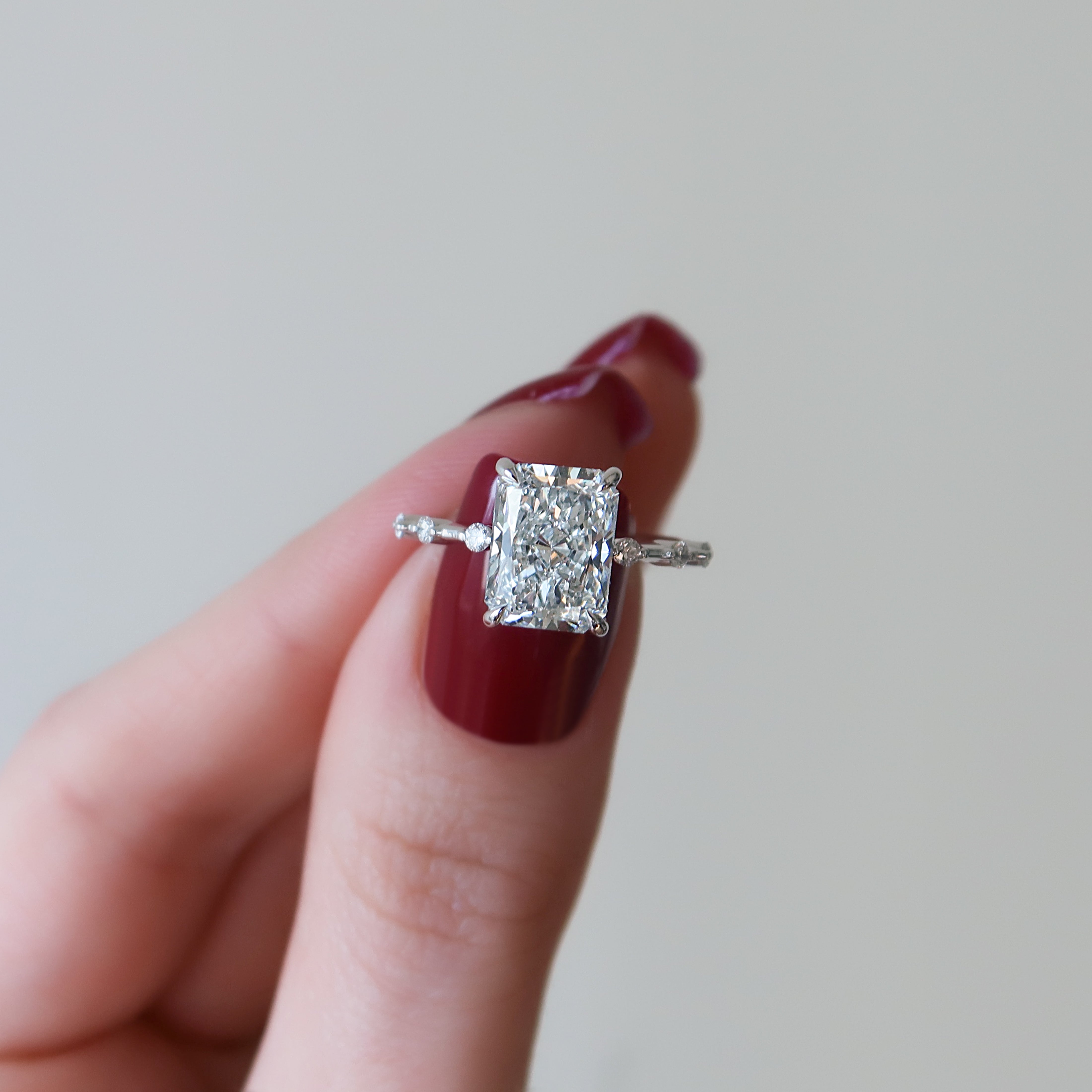 Radiant cut CVD diamond engagement ring with hidden halo in dainty platinum setting