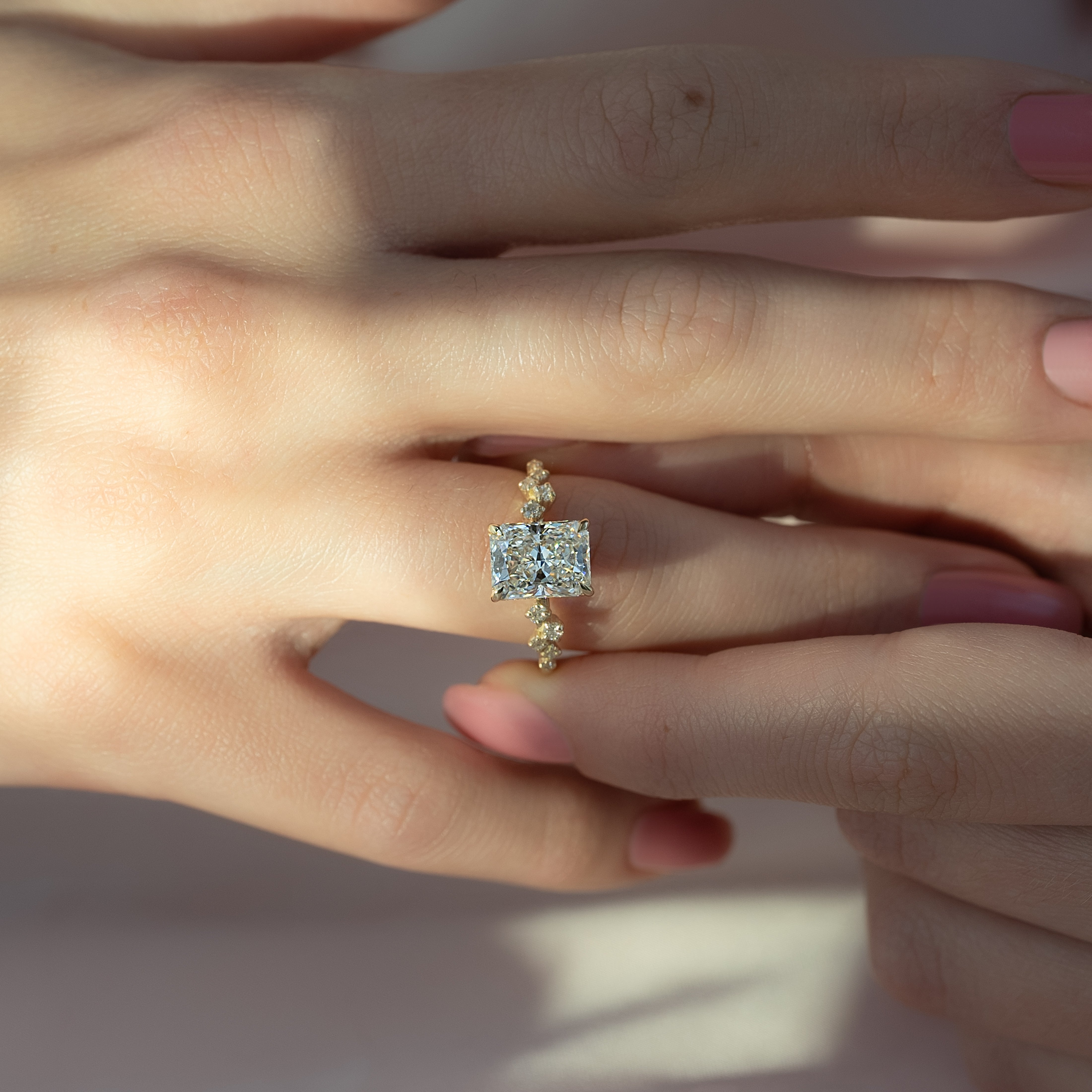 Radiant cut CVD diamond engagement ring with hidden halo and clustered diamond detailing in white gold