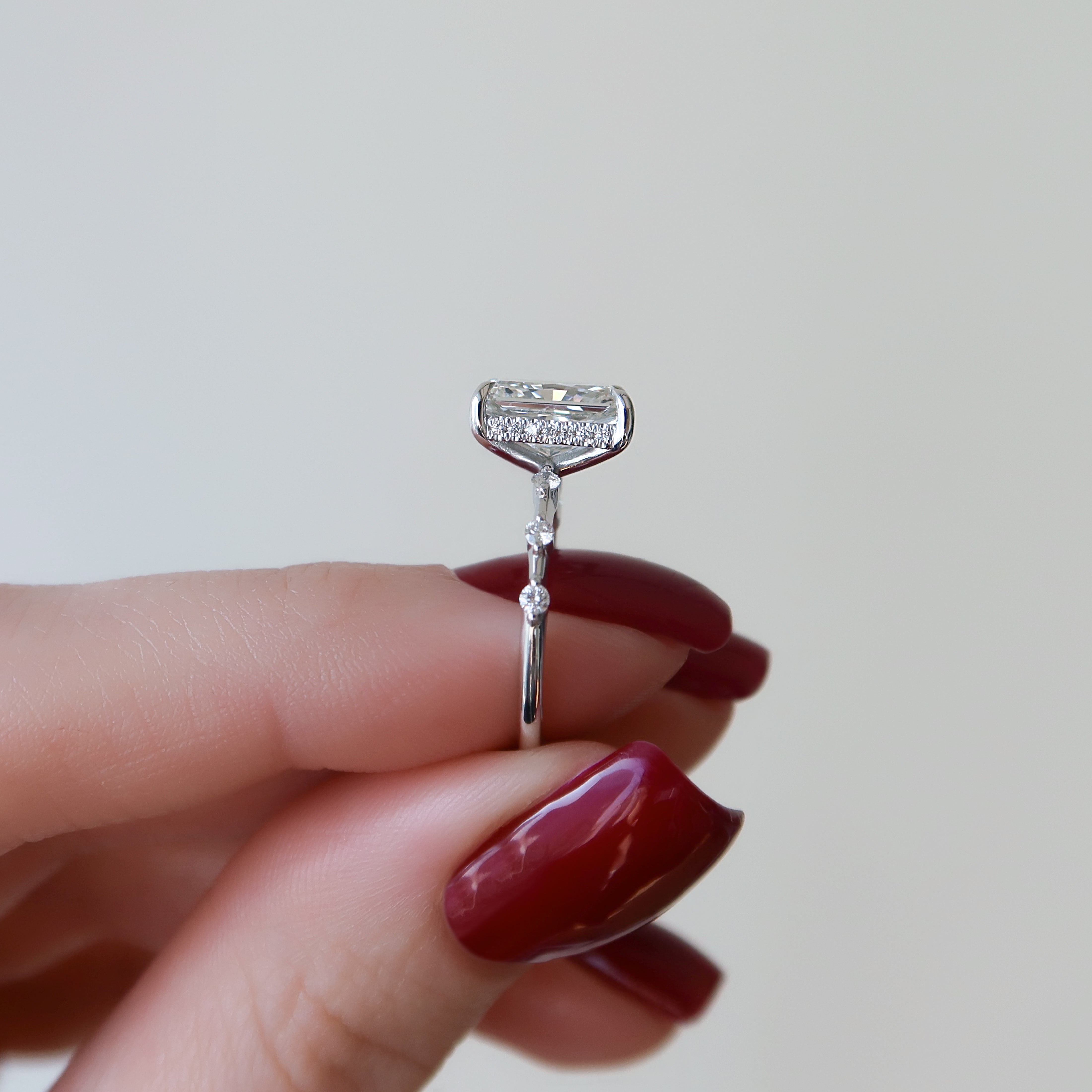 Radiant cut CVD diamond engagement ring with hidden halo in dainty platinum setting