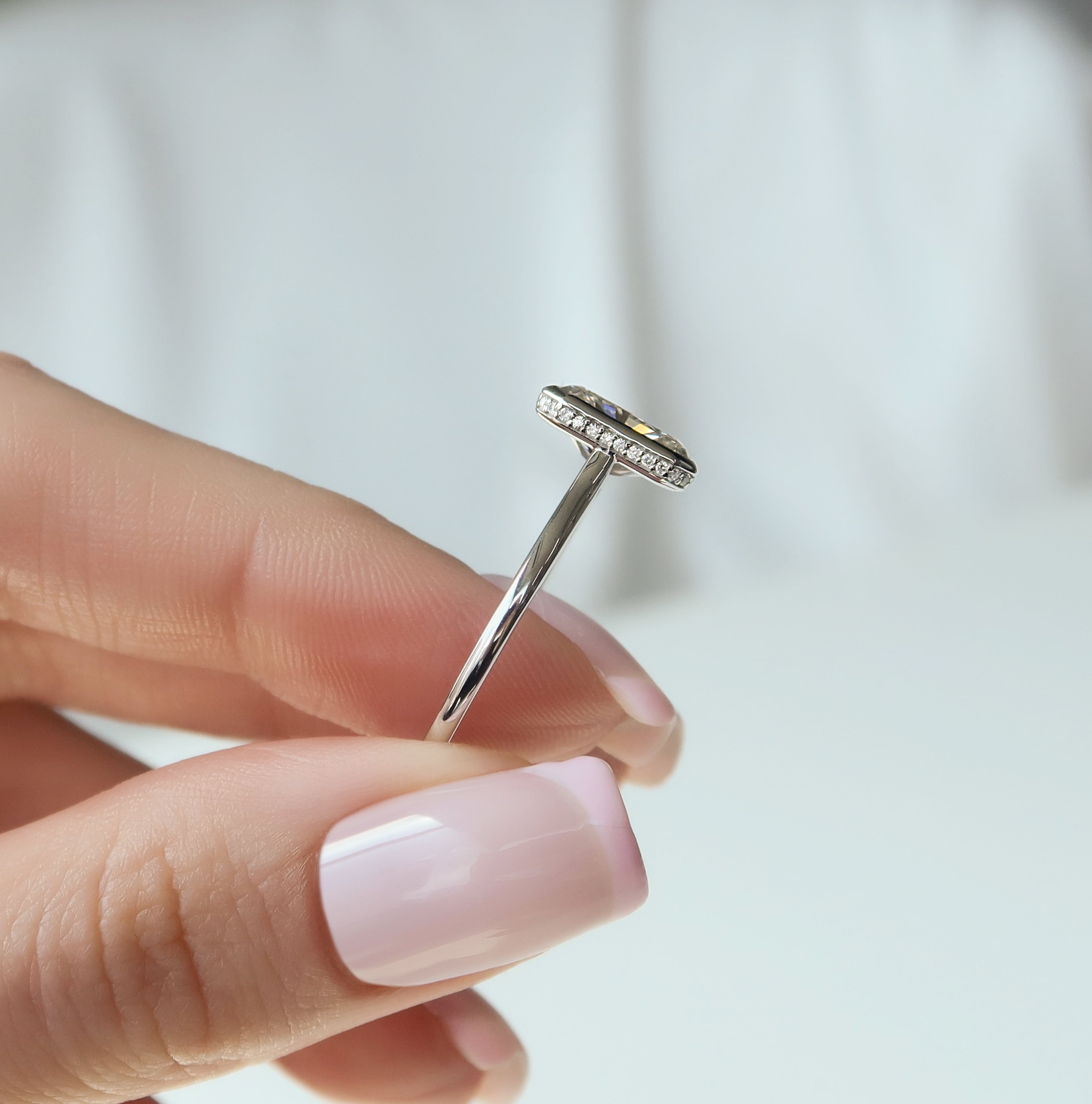 Radiant cut CVD diamond bezel set engagement ring with hidden halo in platinum setting