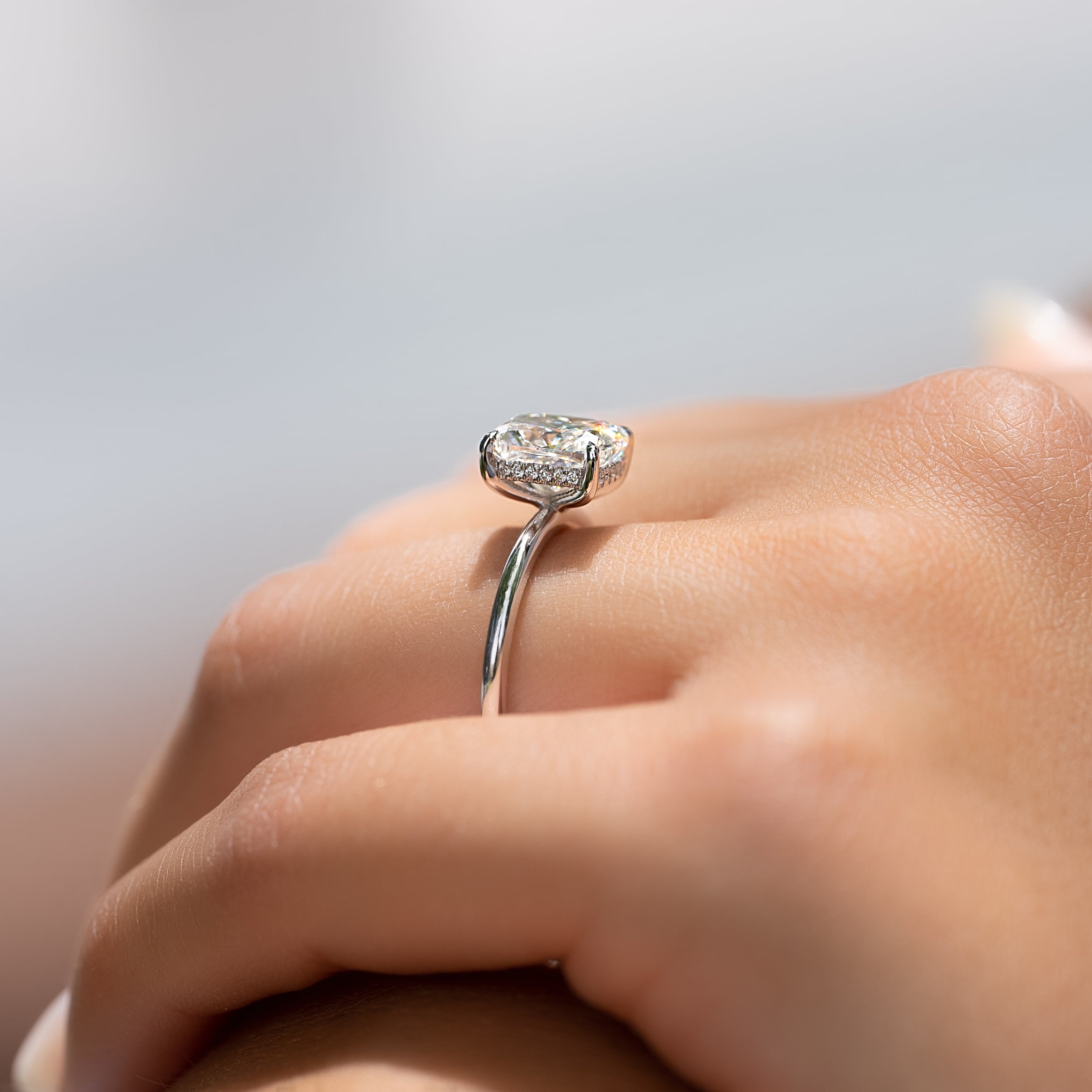 Elongated cushion cut CVD diamond engagement ring with hidden halo setting in white gold