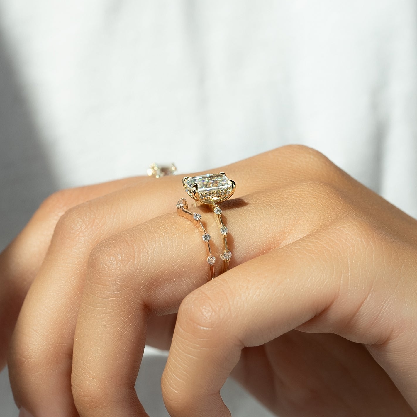 Radiant cut CVD diamond engagement ring with hidden halo in dainty platinum setting