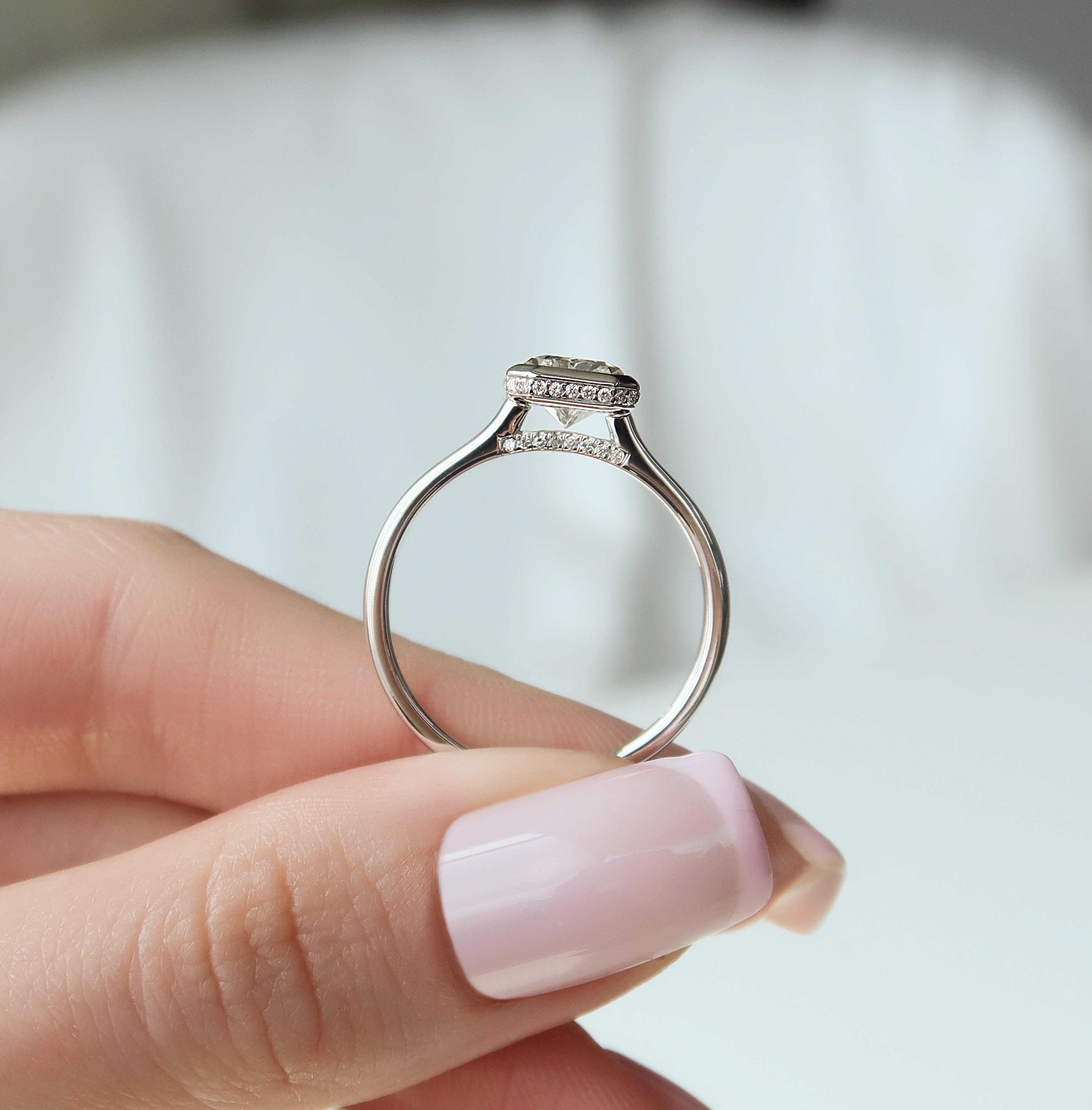 Radiant cut CVD diamond bezel set engagement ring with hidden halo in platinum setting