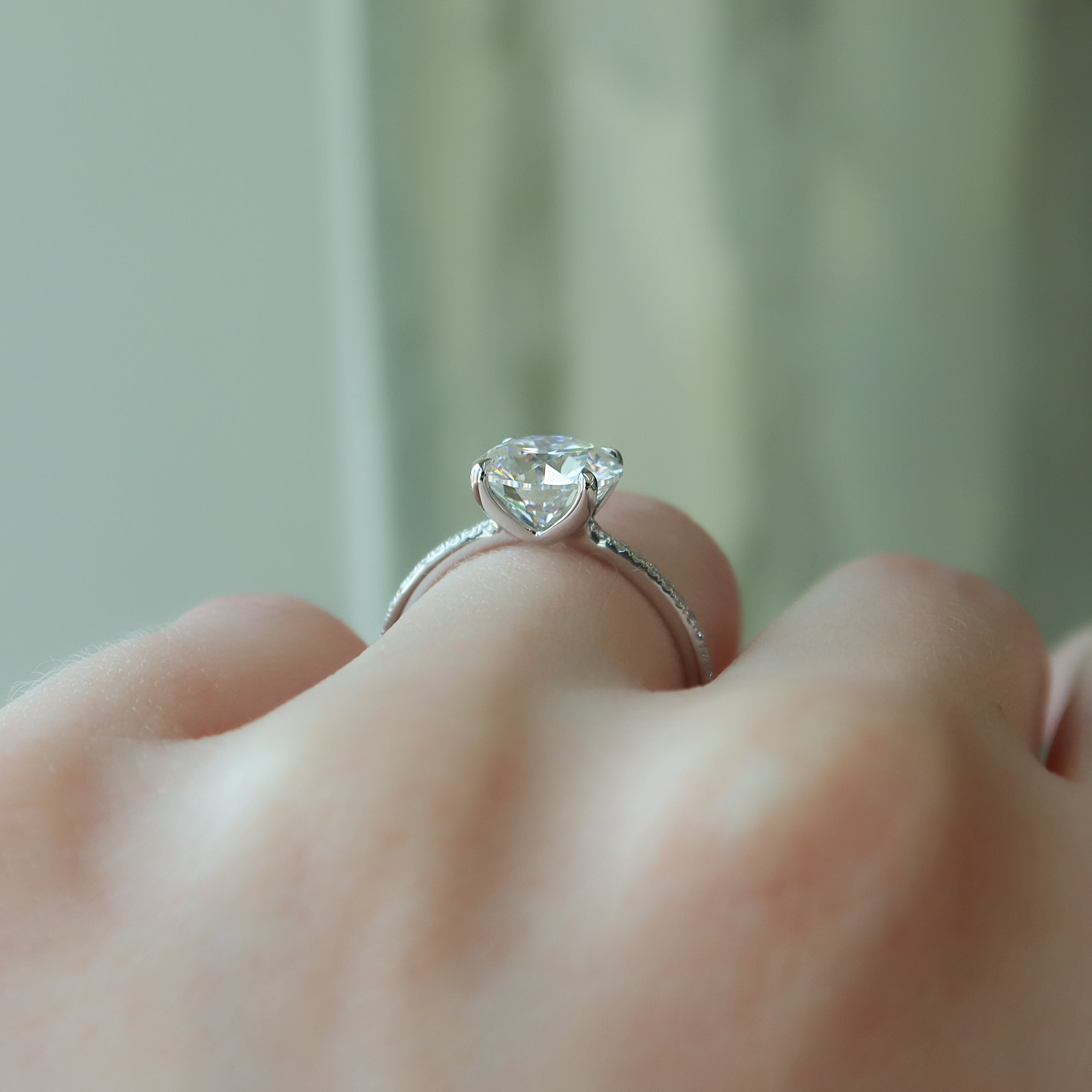 Round cut CVD diamond engagement ring featuring pave diamond band in platinum setting