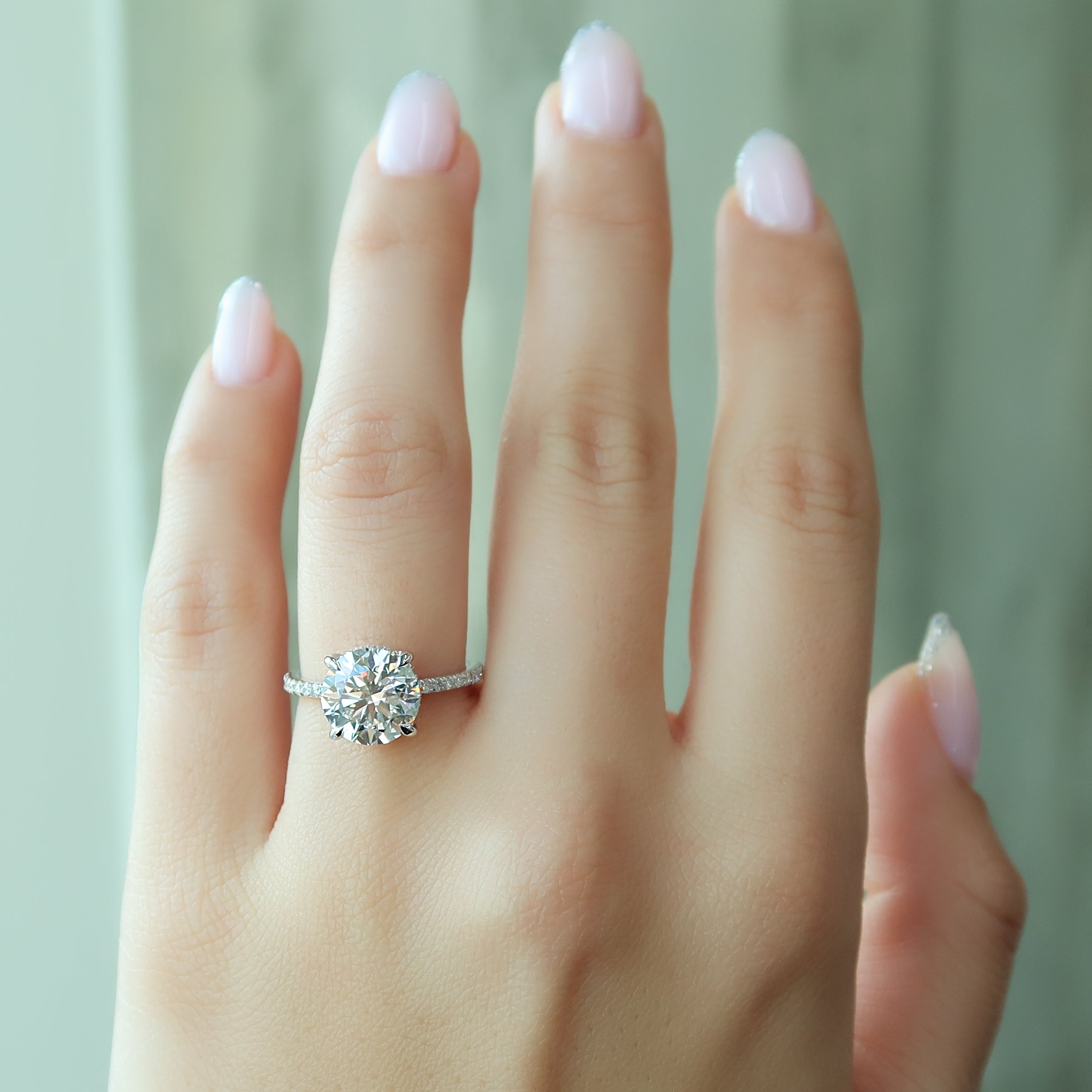 Round cut CVD diamond engagement ring with hidden halo and pave diamond band in white gold