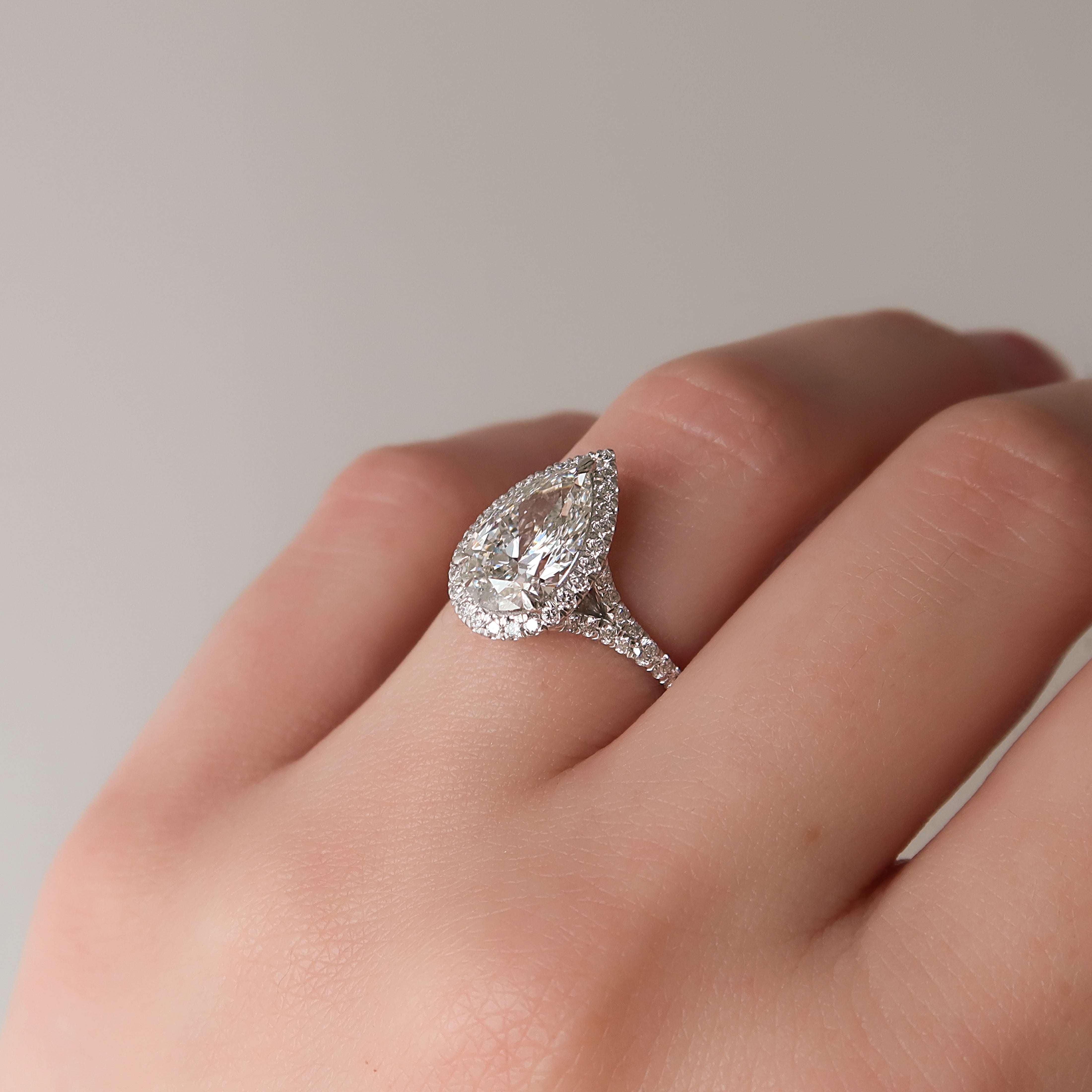 Pear cut CVD diamond halo engagement ring with pave diamond band in white gold